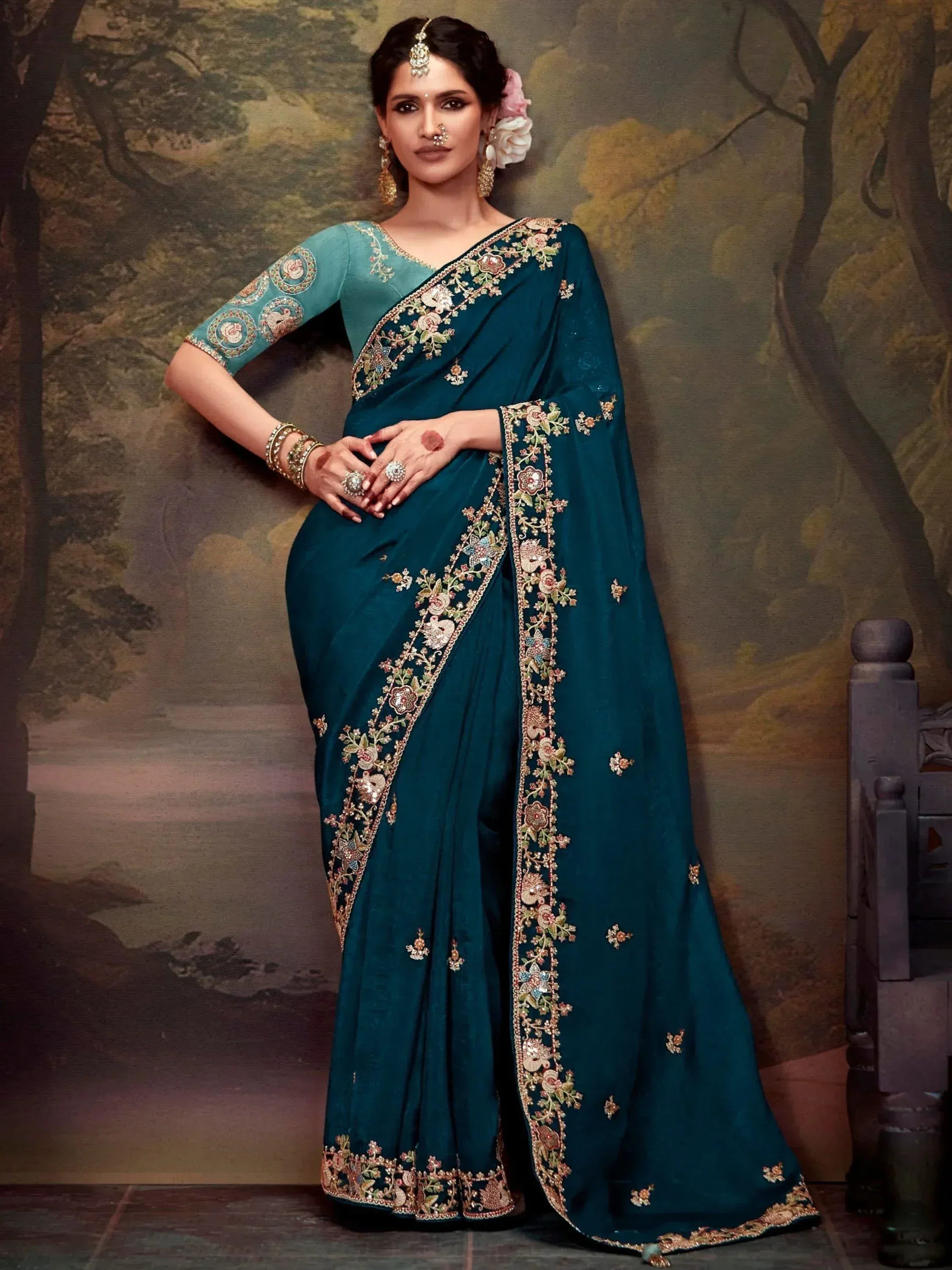 Teal embroidered saree with floral border, perfect for Indian ethnic wear and festive occasions