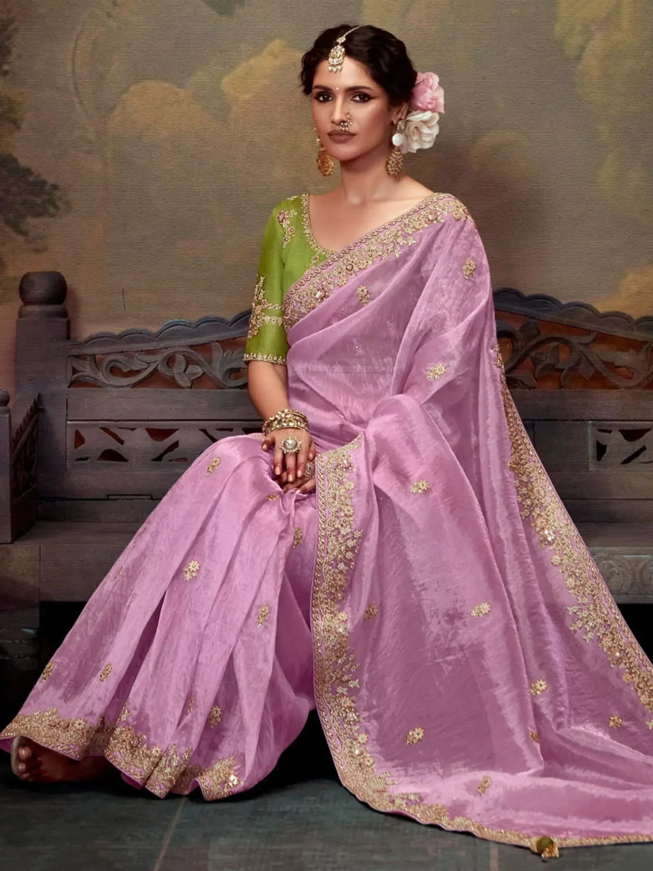 Woman in lavender silk saree with gold embroidery, green blouse, traditional Indian ethnic wear