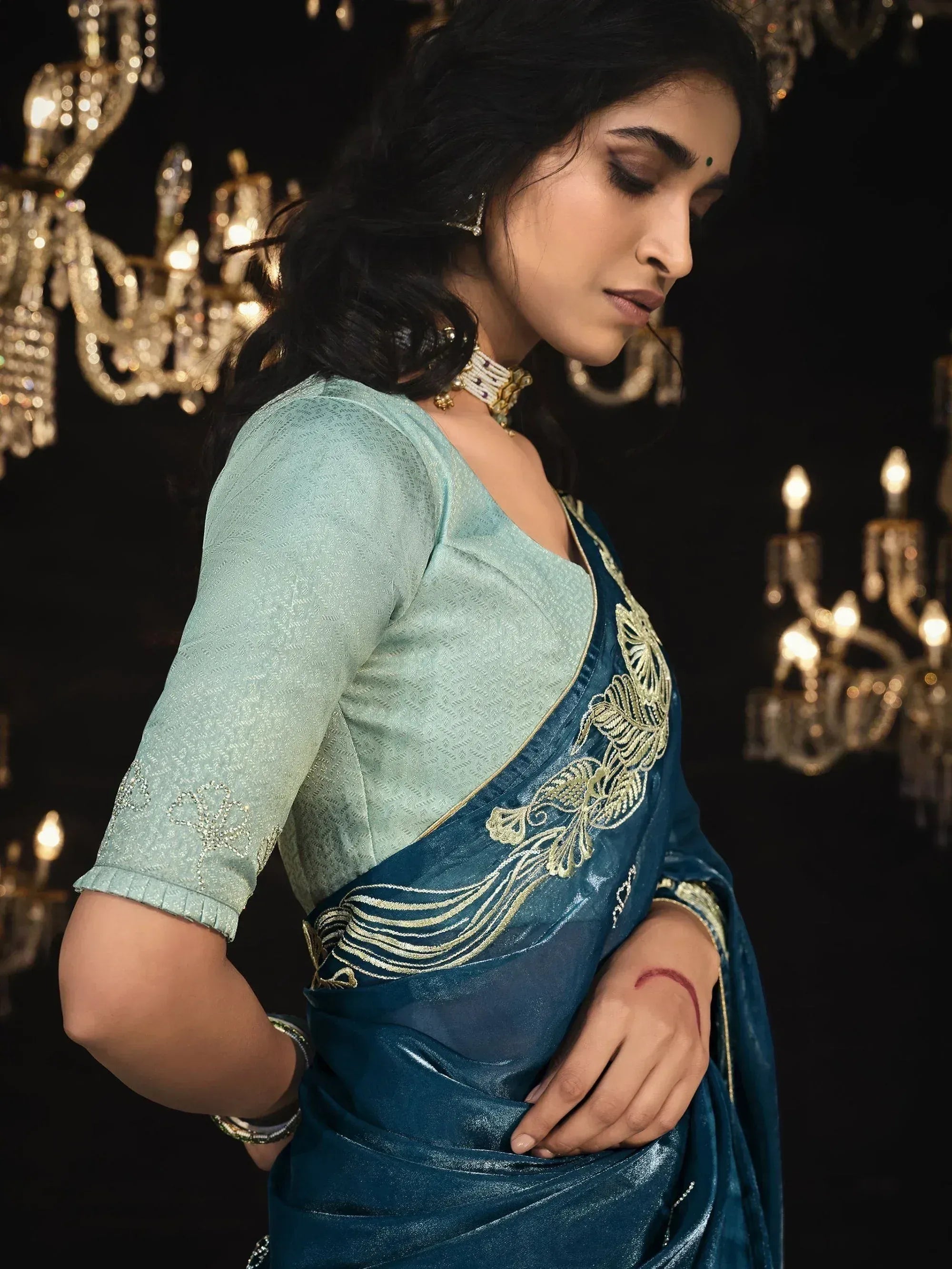 Elegant blue velvet saree with gold embroidery, paired with light green blouse, perfect for Indian ethnic wear occasions.