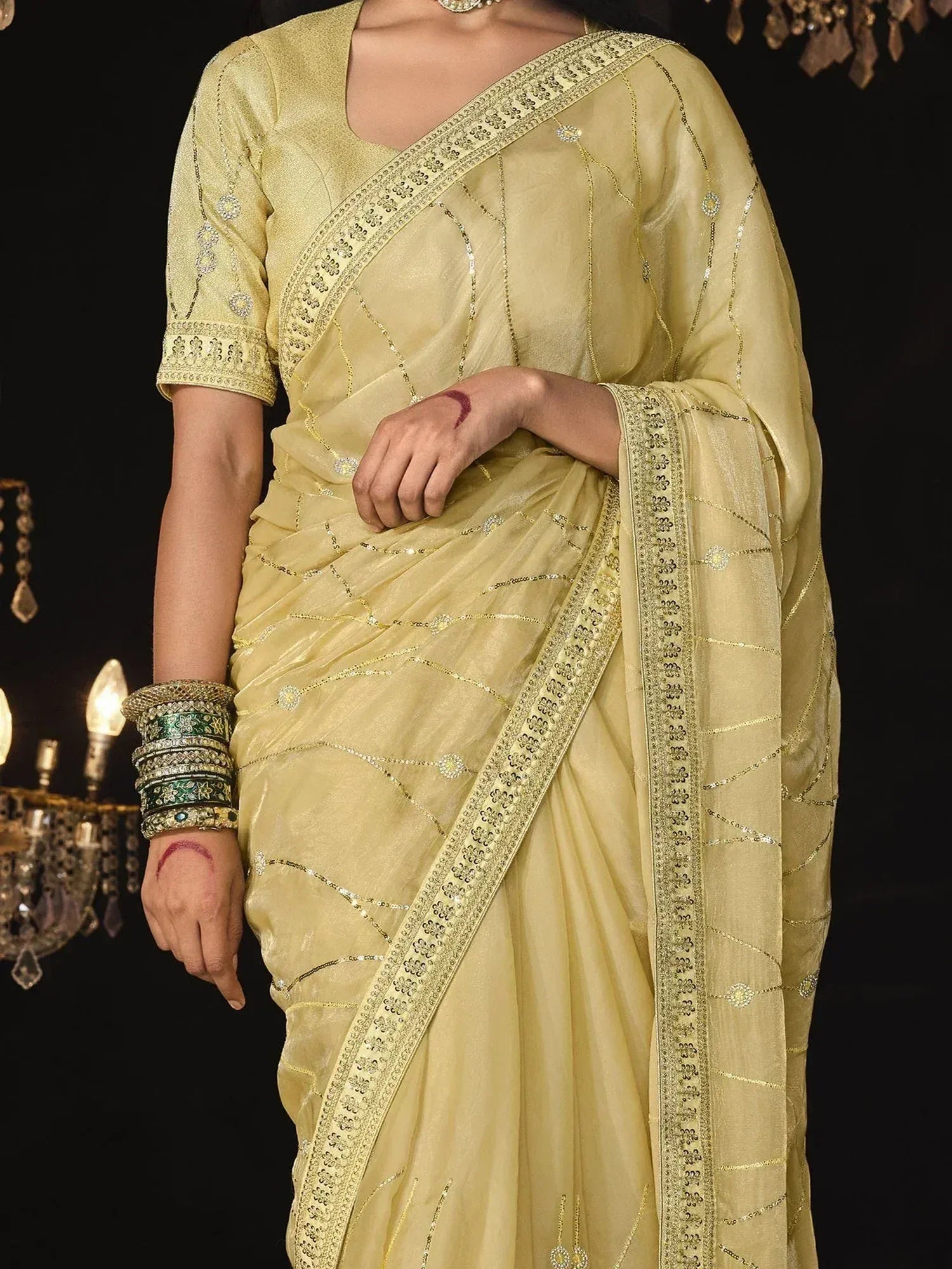 Elegant light yellow saree with gold embroidery and sequin detailing, perfect for Indian ethnic occasions.