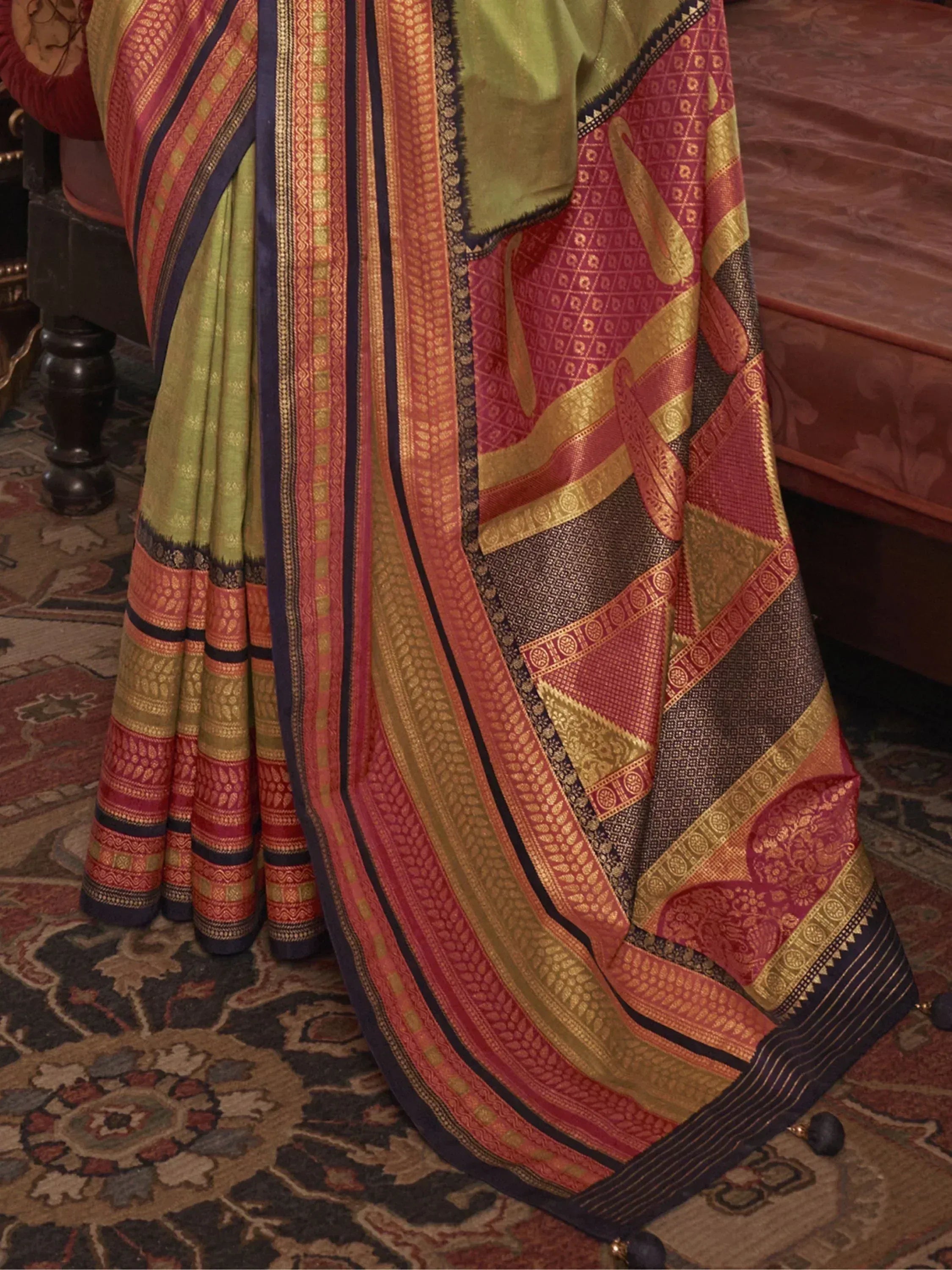 Elegant Indian saree with intricate gold and red patterns, perfect for ethnic wear occasions.