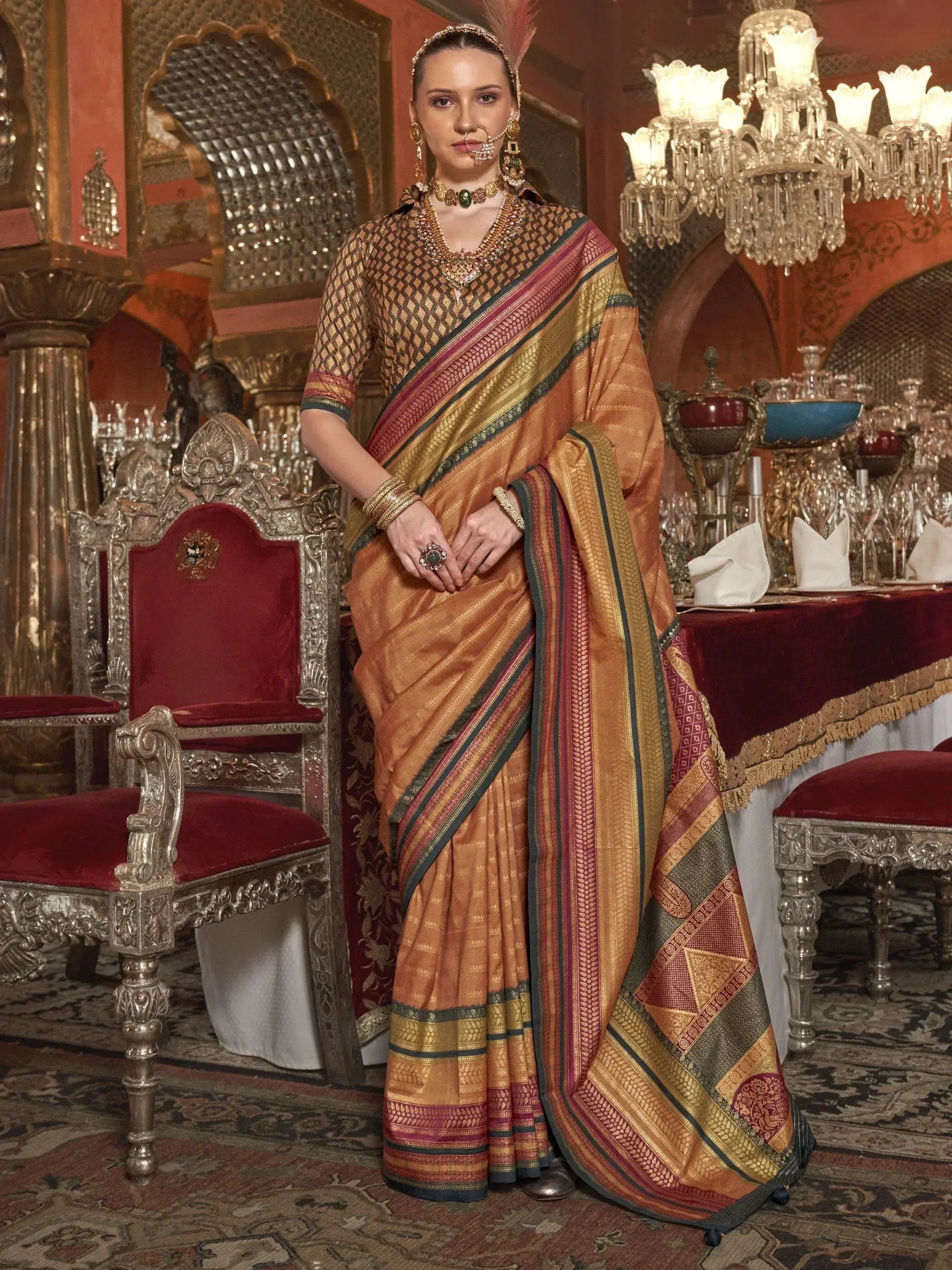 Woman in traditional Indian saree with gold and maroon border, ornate jewelry, palace setting