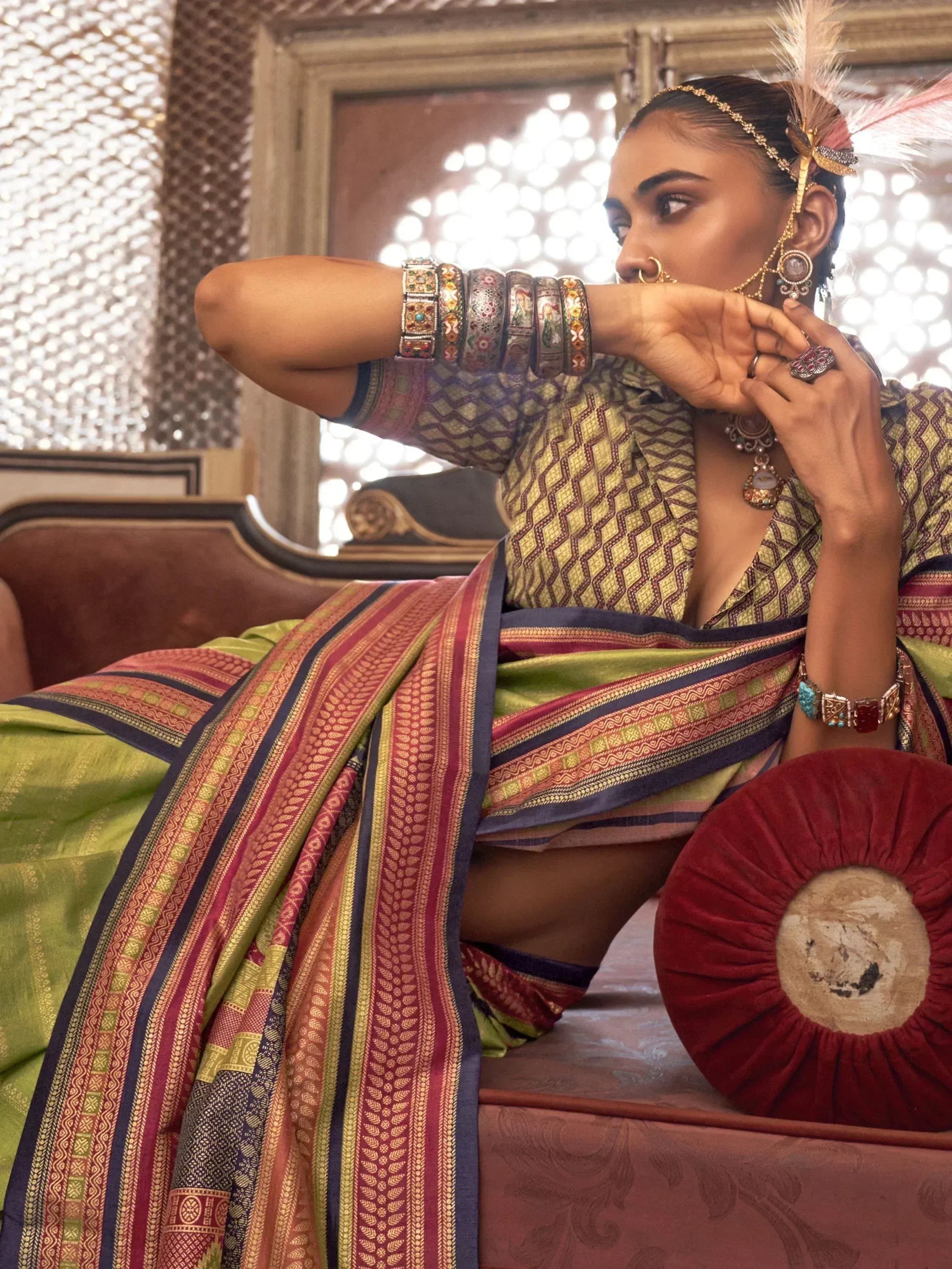 Elegant woman in vibrant Indian saree with intricate patterns and traditional jewelry, exuding ethnic charm.