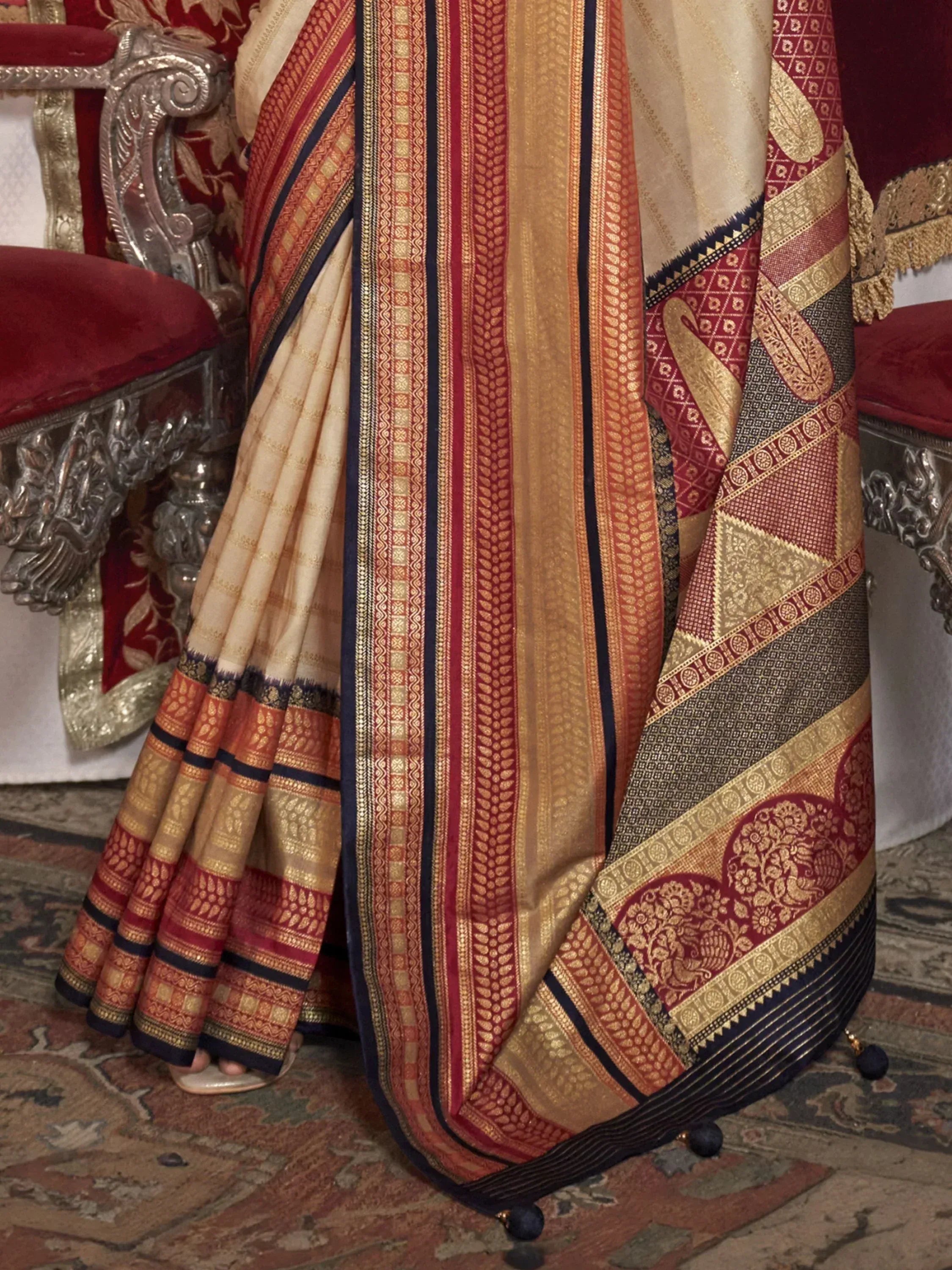 Elegant cream and maroon designer saree with gold zari work, perfect for Indian ethnic wear occasions.