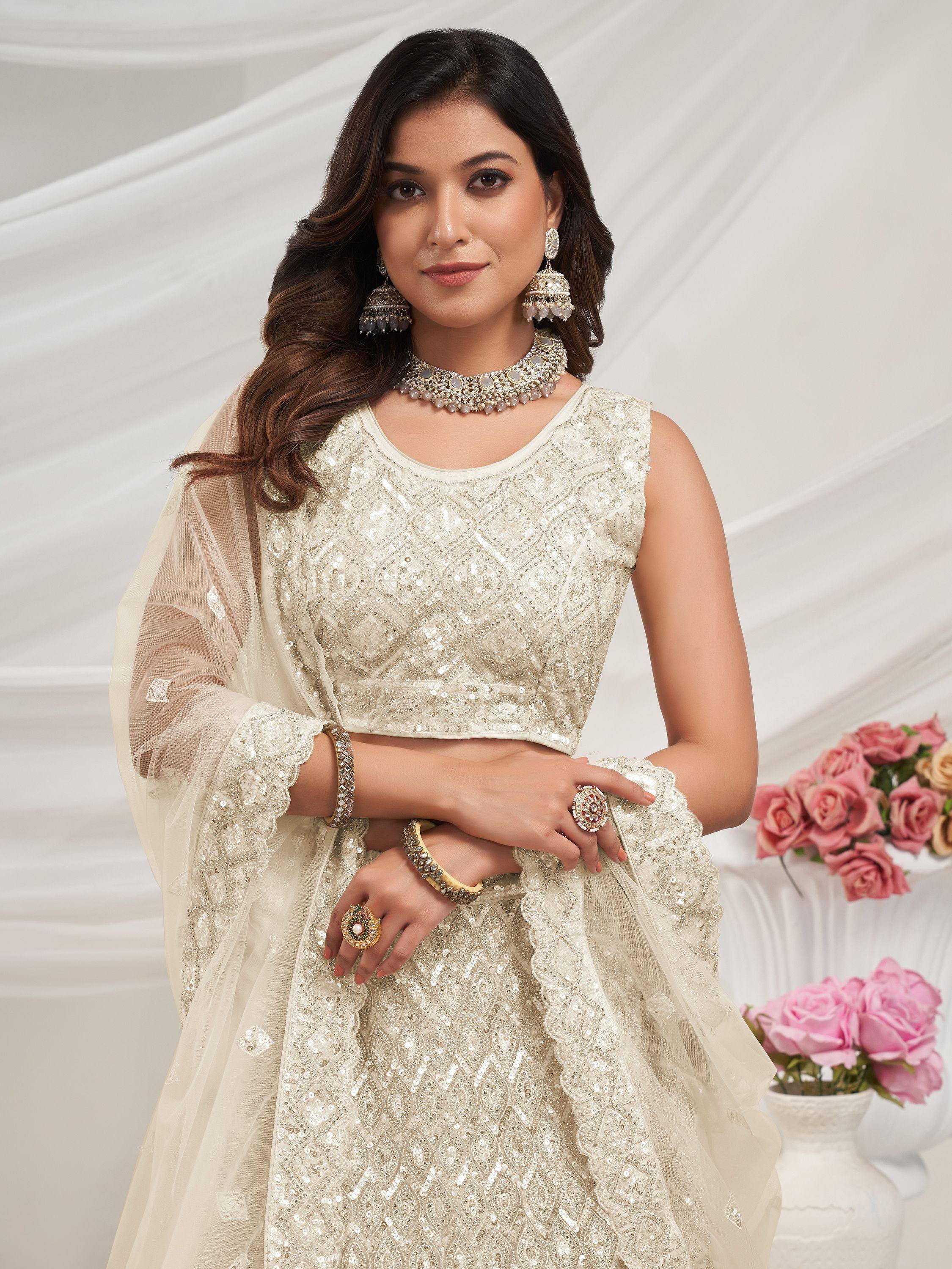 Elegant ivory sequin lehenga choli with sheer dupatta, perfect for Indian weddings and festive occasions.