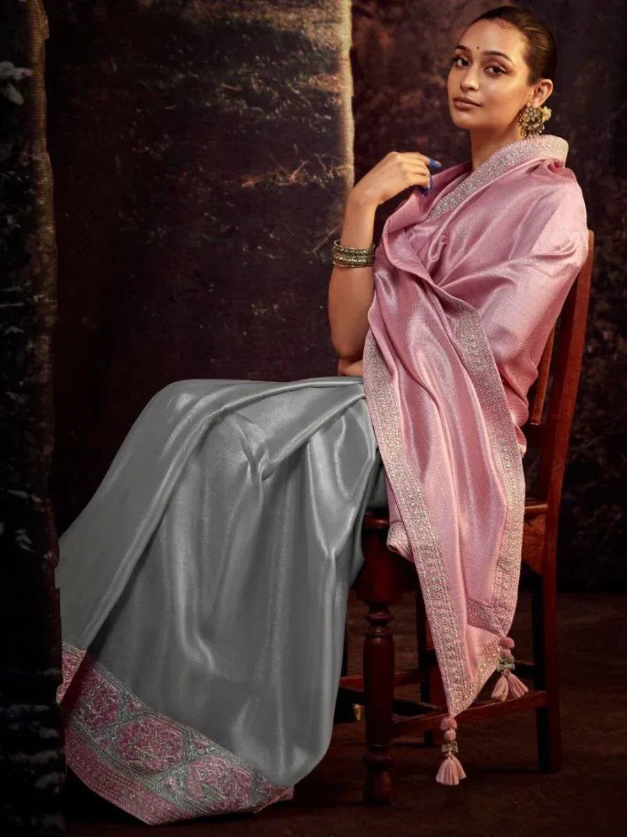 Pink and silver designer saree with embroidered border and tassels, styled for ethnic occasions