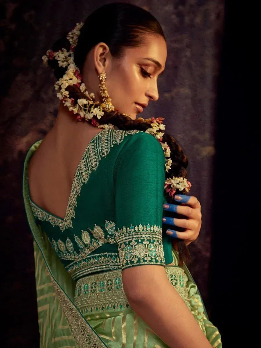 Emerald green embroidered saree with floral hair accessories, perfect for Indian ethnic wear occasions