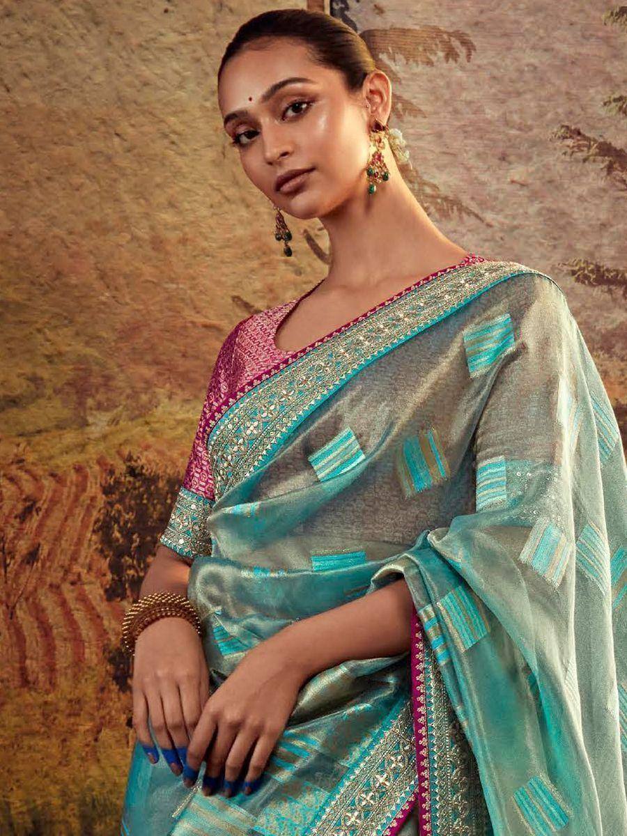 Elegant teal and pink designer saree with intricate embroidery and sequin work, perfect for Indian ethnic occasions.