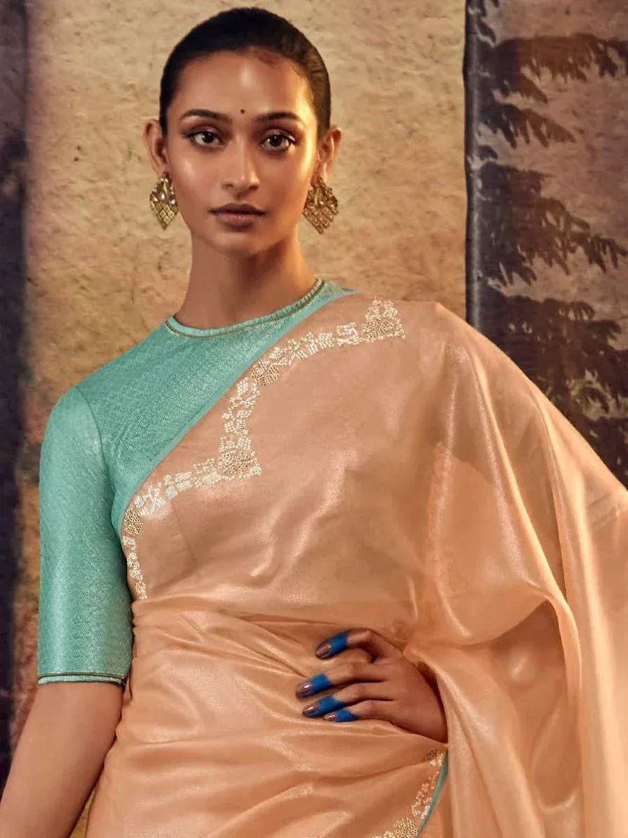 Elegant peach saree with gold embroidery and mint green blouse, perfect for Indian ethnic occasions