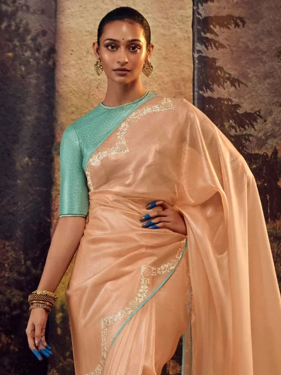 Elegant peach saree with gold embroidery and mint green blouse, styled for Indian ethnic wear