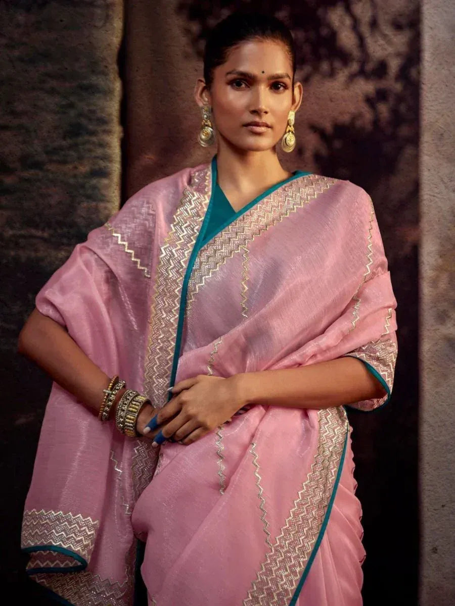 Pink saree with gold zigzag border and teal blouse, ethnic Indian wear