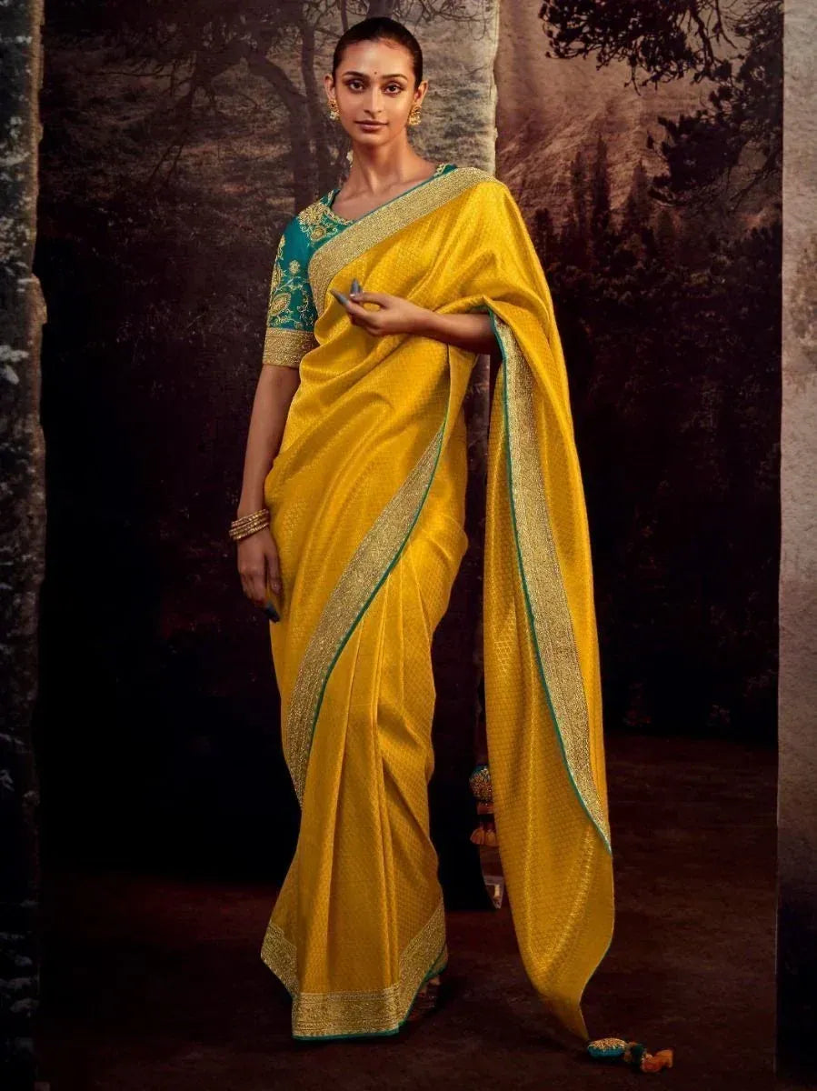 Yellow silk saree with gold border and teal blouse, Indian ethnic wear for women