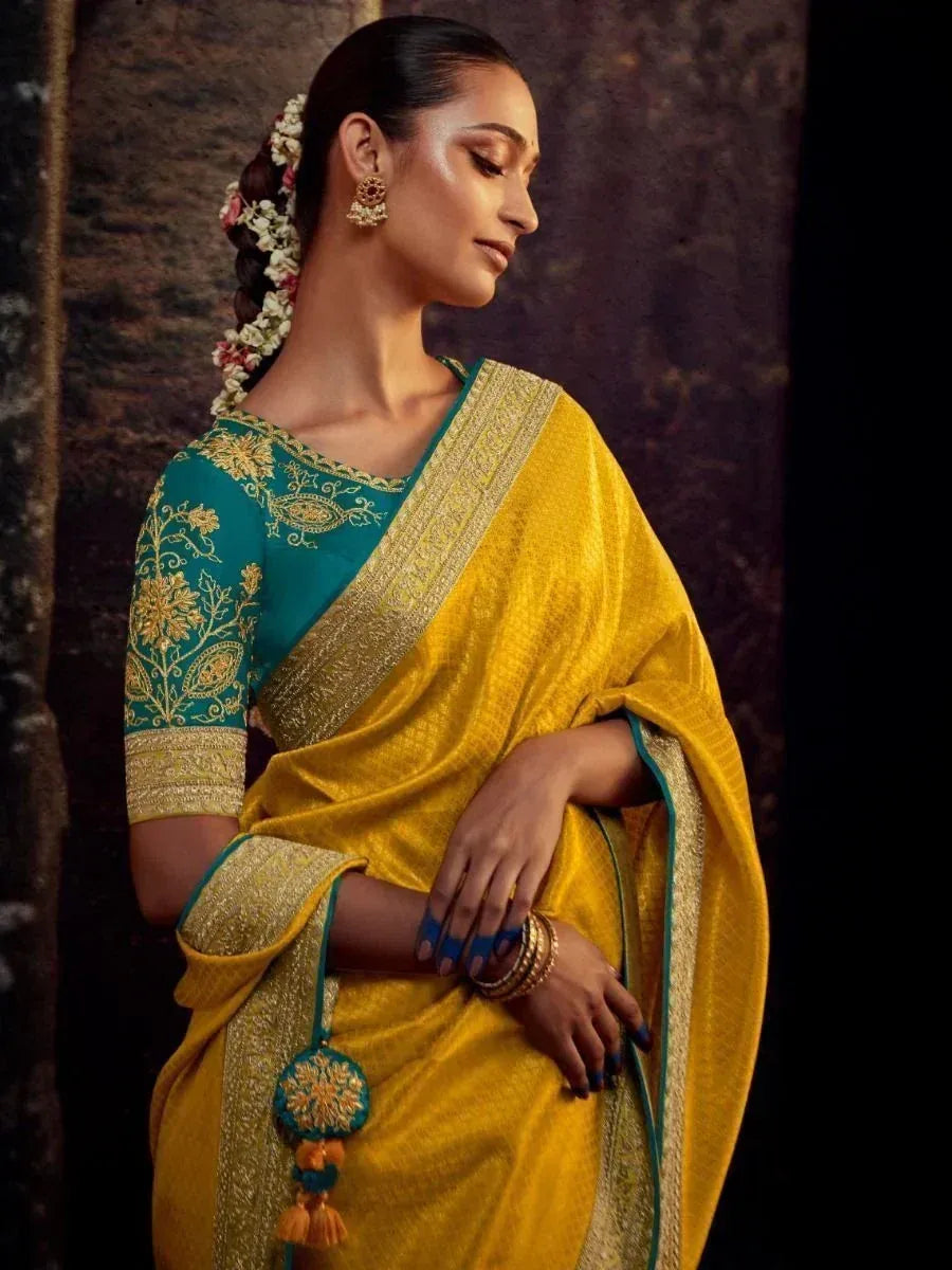Yellow and teal designer saree with gold embroidery, perfect for ethnic occasions