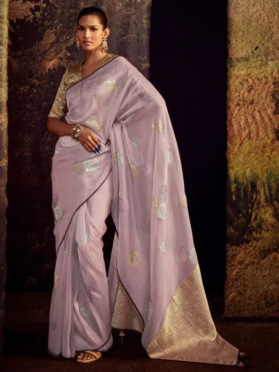 Lavender saree with gold floral motifs and embroidered border, paired with matching blouse for ethnic wear