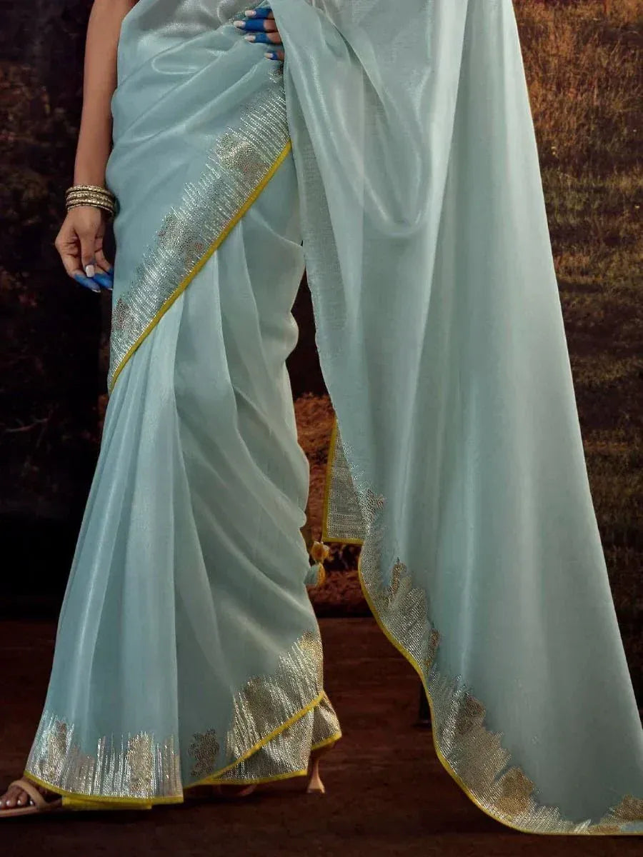 Light blue saree with gold zari border, perfect for Indian ethnic wear and festive occasions.