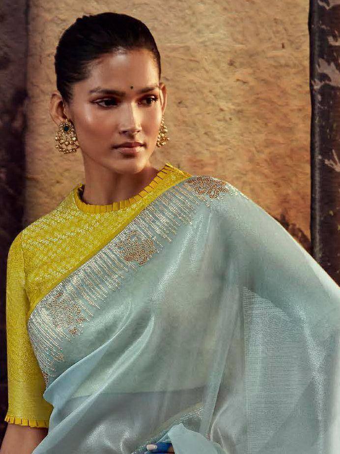 Elegant light blue saree with gold embroidery paired with yellow blouse, perfect for Indian ethnic wear occasions