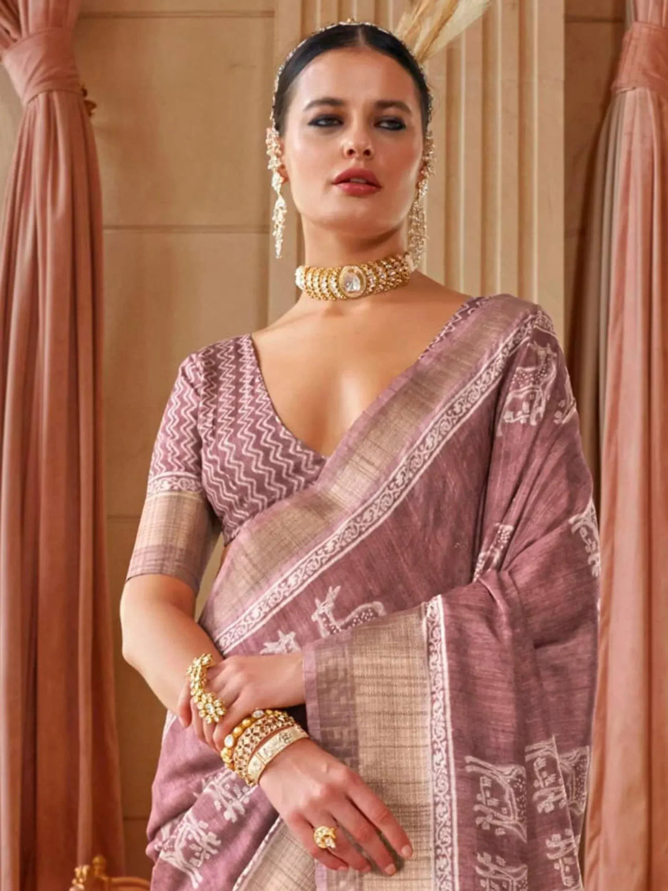 Elegant mauve printed saree with gold jewelry, perfect for Indian ethnic wear occasions
