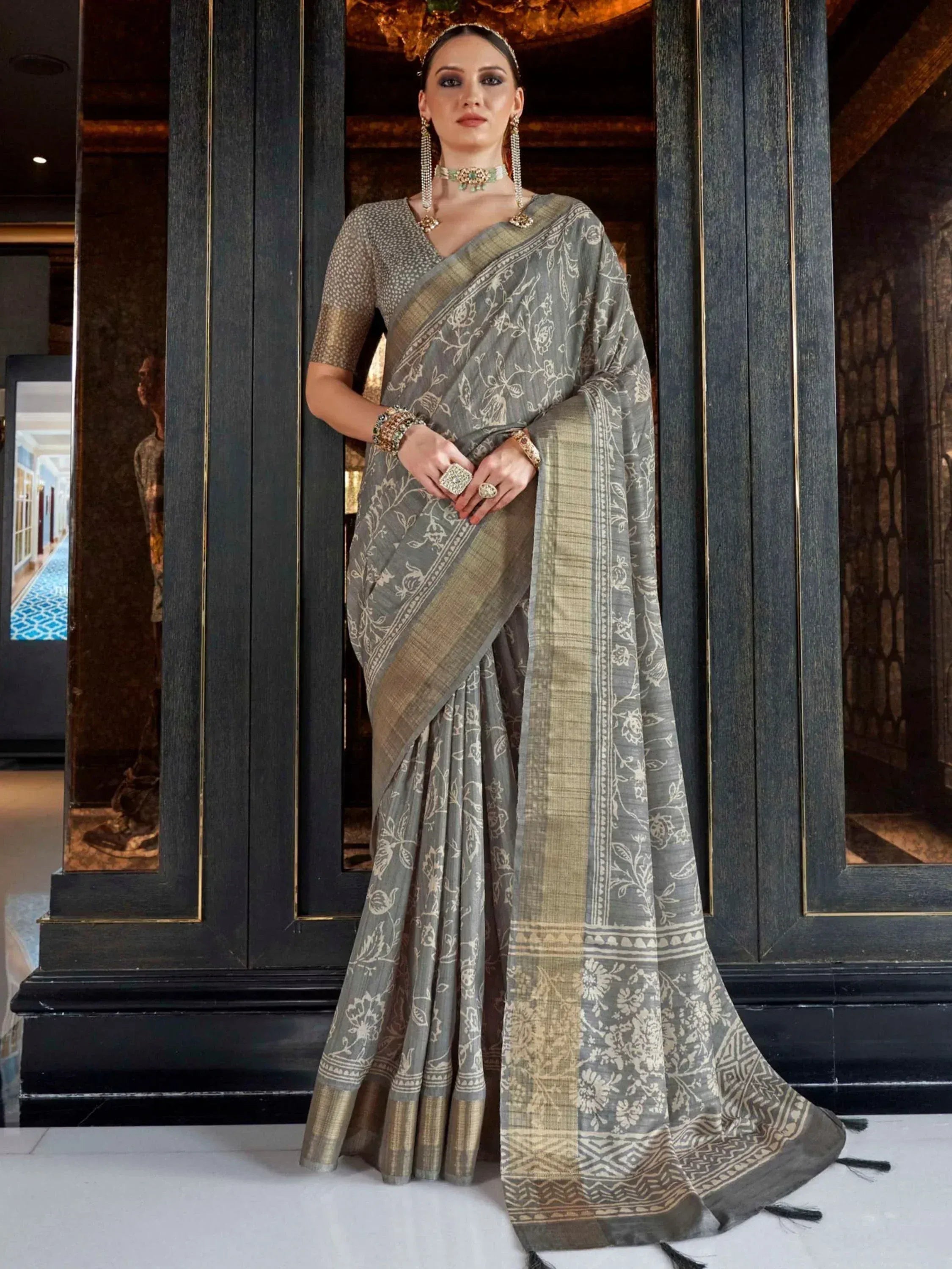 Grey floral printed saree with gold border, paired with matching blouse, perfect for Indian ethnic wear occasions.