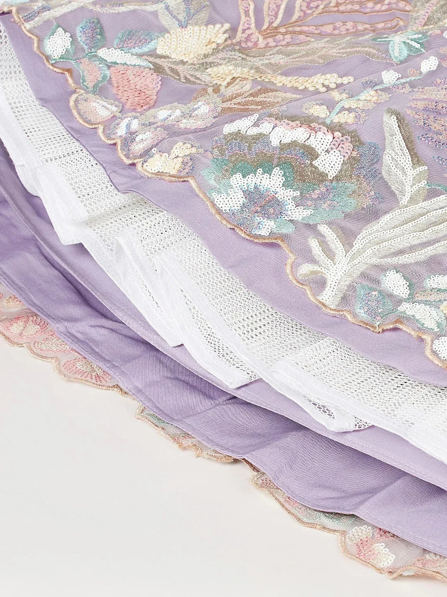Lavender ethnic gown with floral embroidery and lace detailing, perfect for Indian occasions