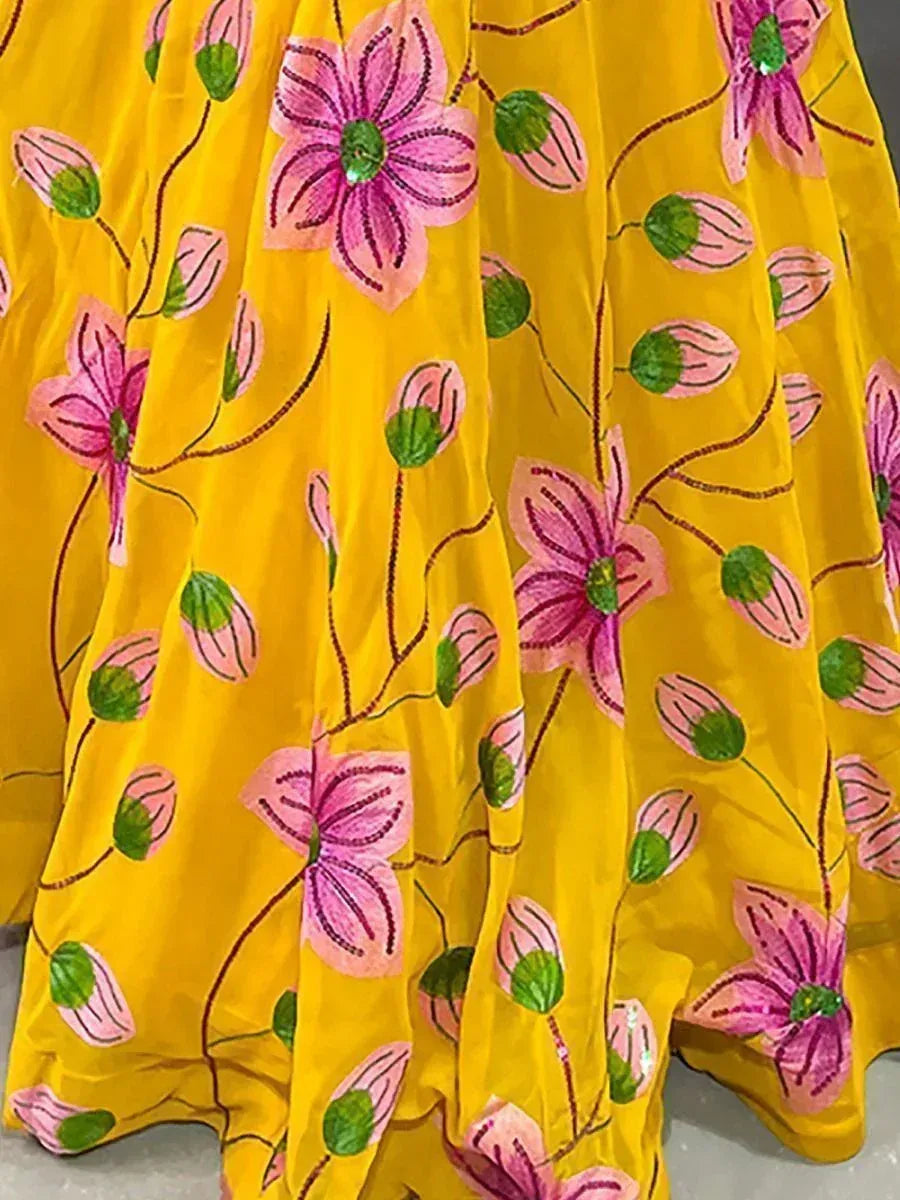 Yellow ethnic gown with pink floral embroidery, perfect for Indian occasions and festive wear.