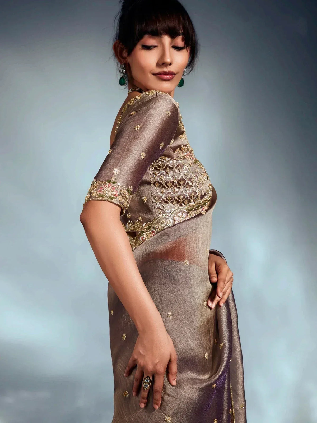 Elegant brown saree with gold embroidery and floral motifs, perfect for Indian ethnic wear occasions.