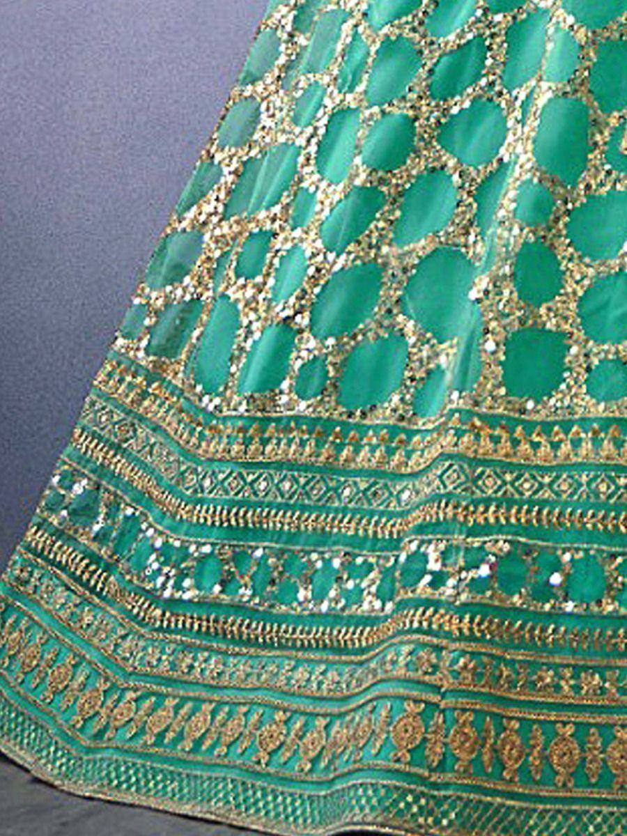 Emerald green lehenga with gold embroidery and sequin detailing, ethnic Indian wear