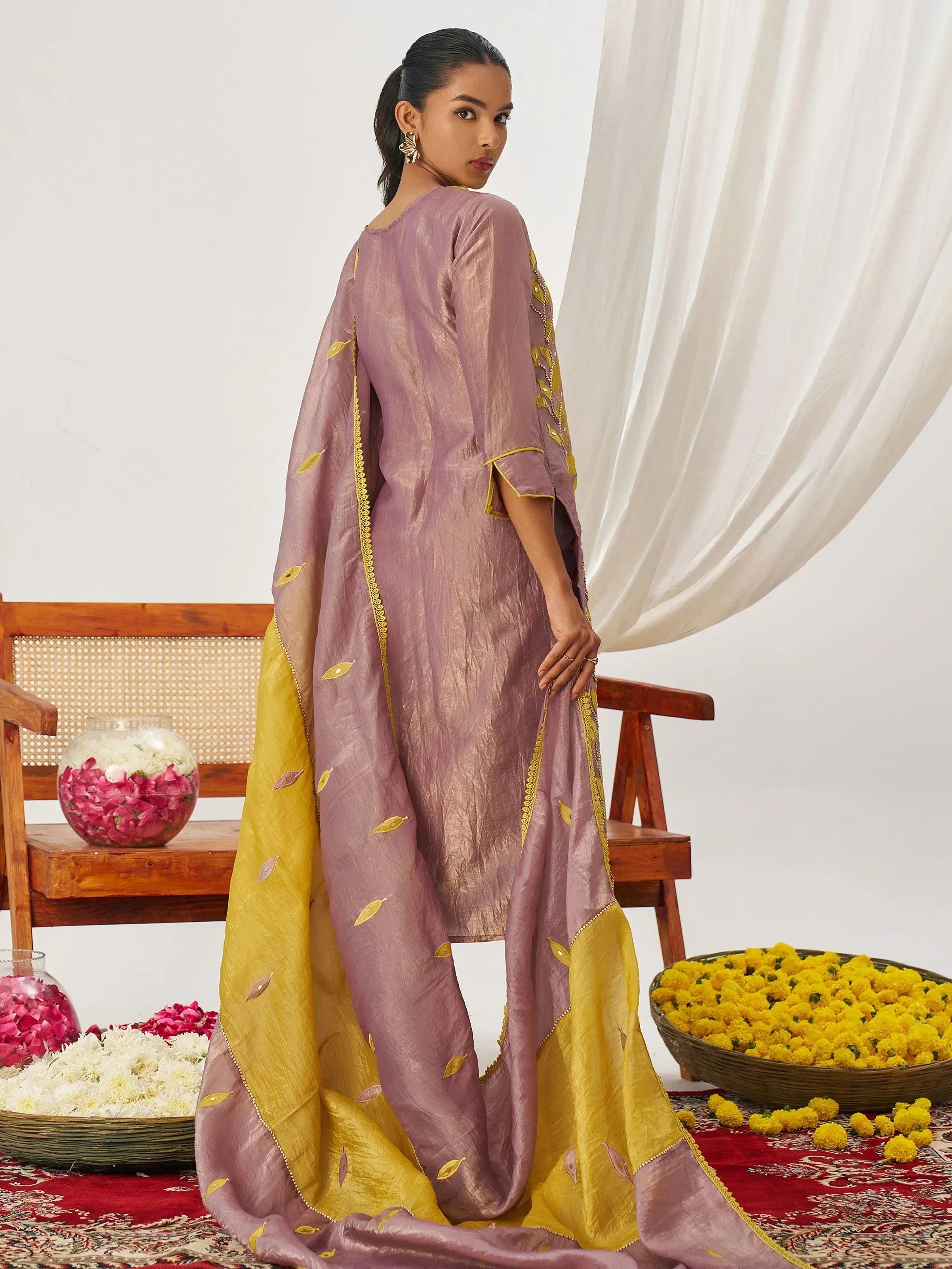 Elegant mauve and gold embroidered salwar kameez with floral accents, perfect for Indian ethnic wear occasions.
