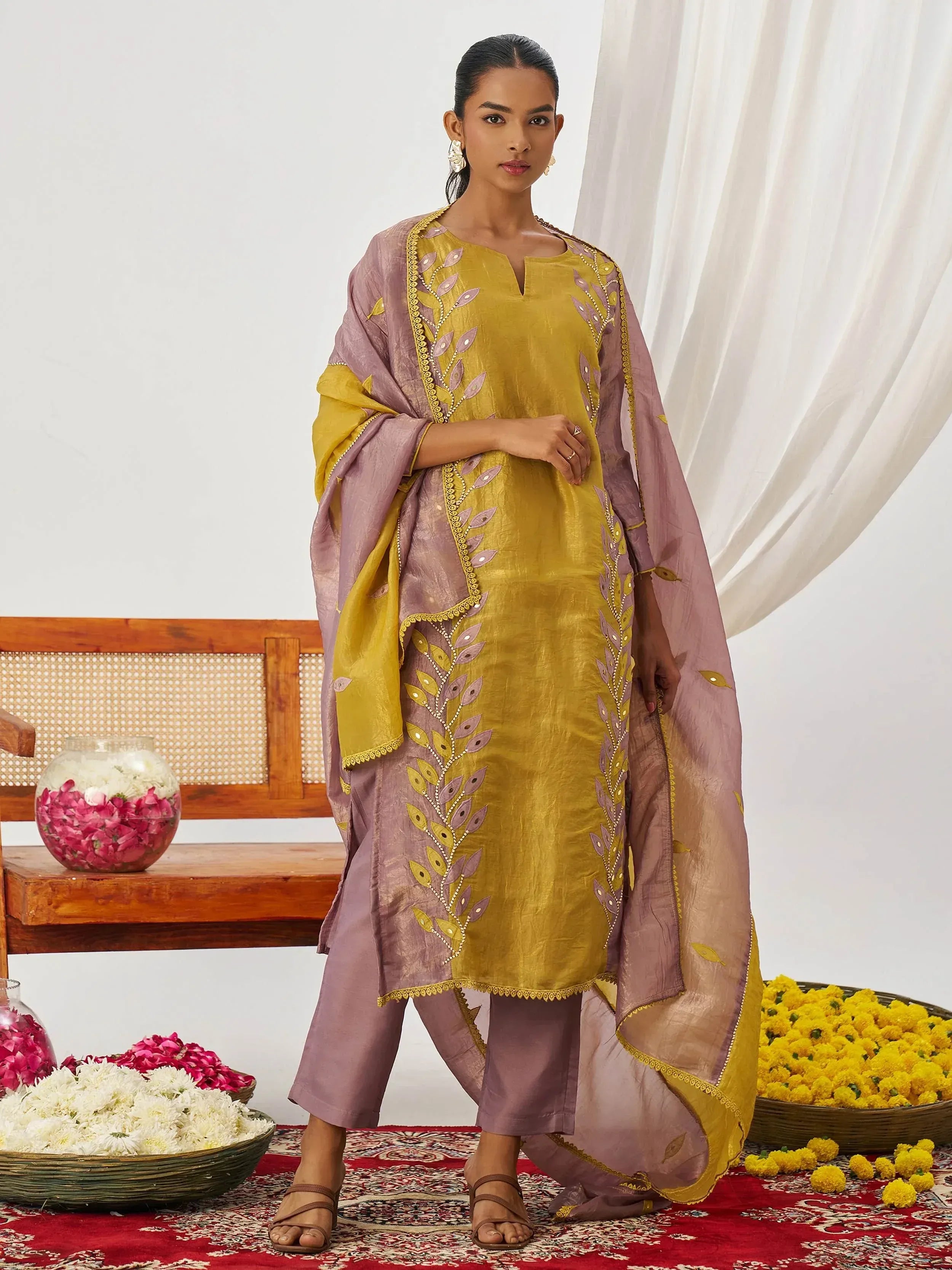 Yellow and mauve embroidered salwar kameez with floral motifs, perfect for Indian ethnic wear occasions.