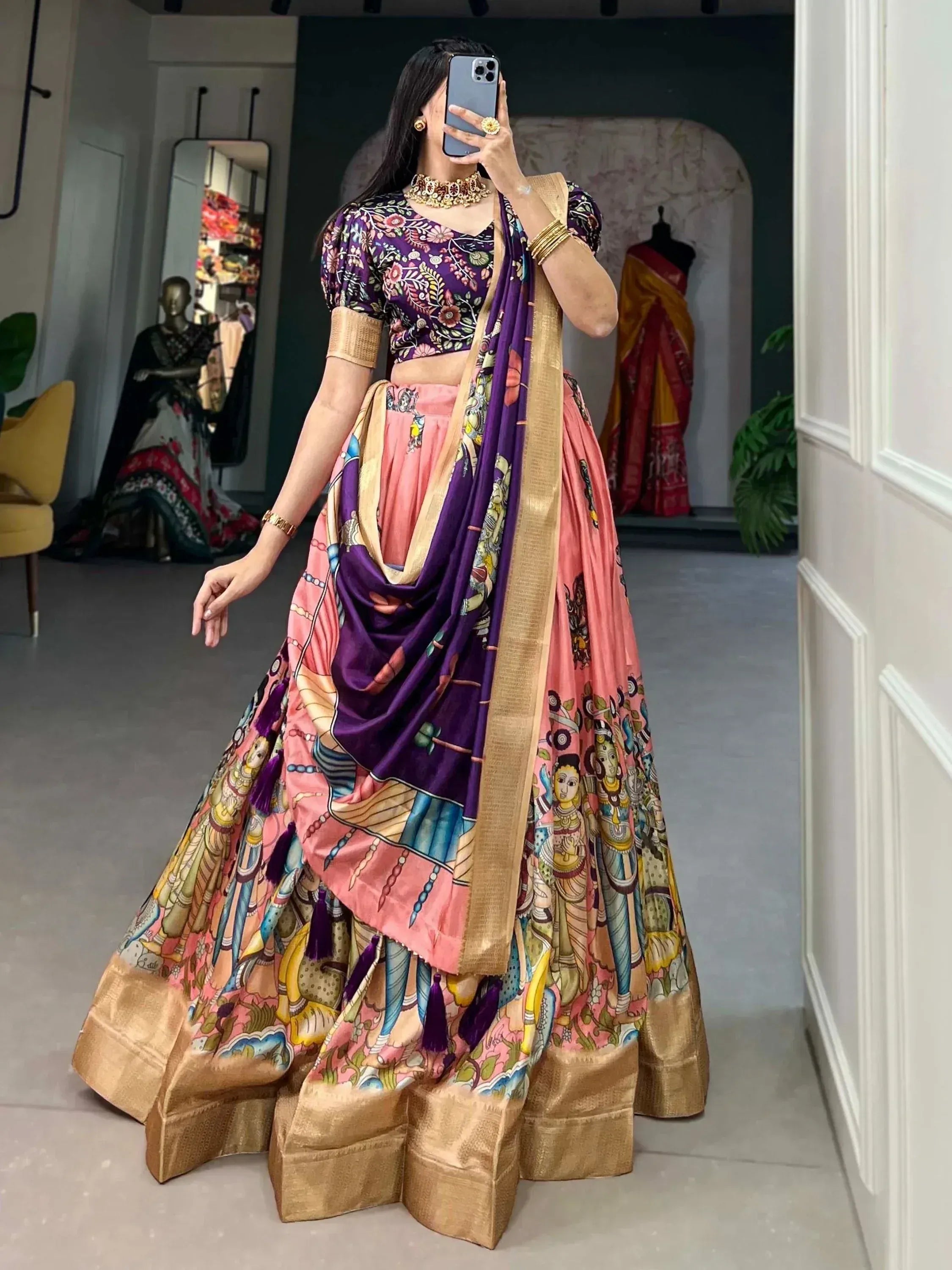 Woman in purple floral blouse and pink printed lehenga choli with gold border, ethnic Indian wear