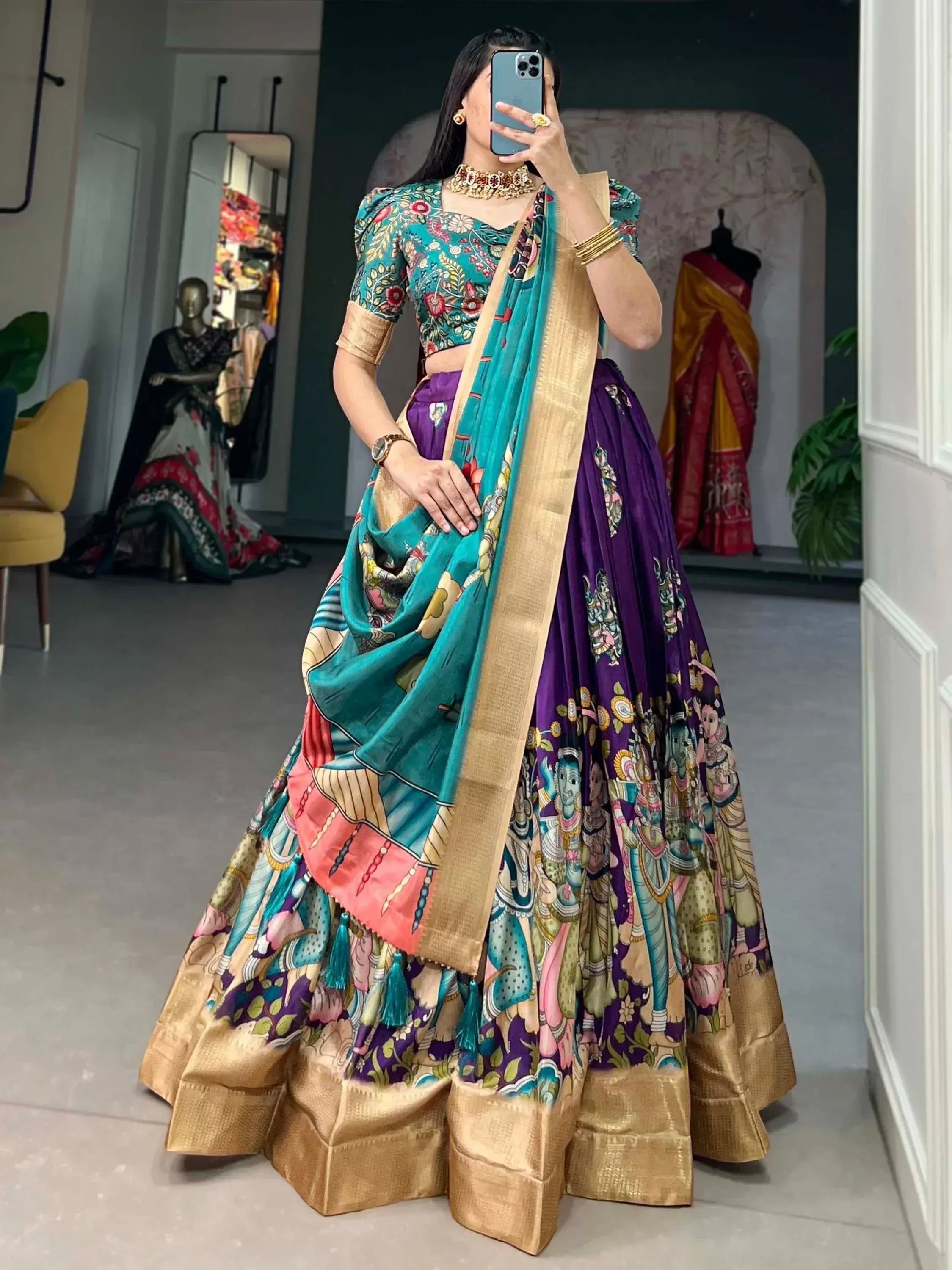 Woman in vibrant purple and teal printed lehenga choli with gold border, perfect for Indian ethnic occasions