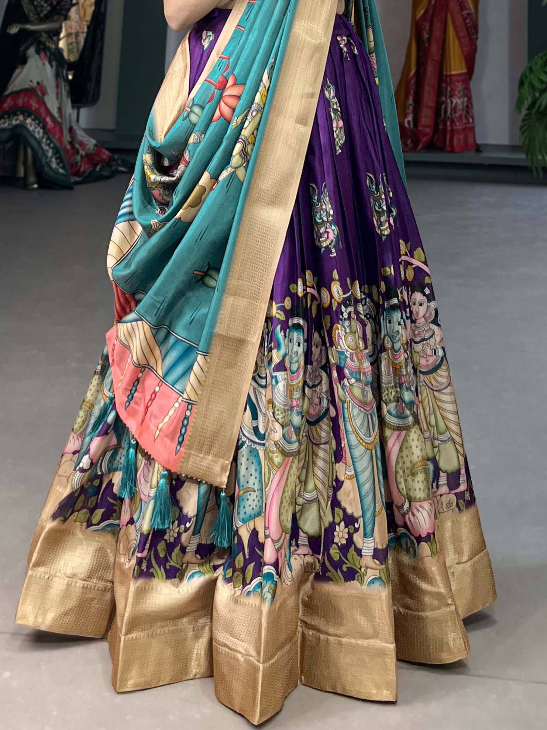 Purple and teal printed lehenga choli with gold border and deity motifs, Indian ethnic wear
