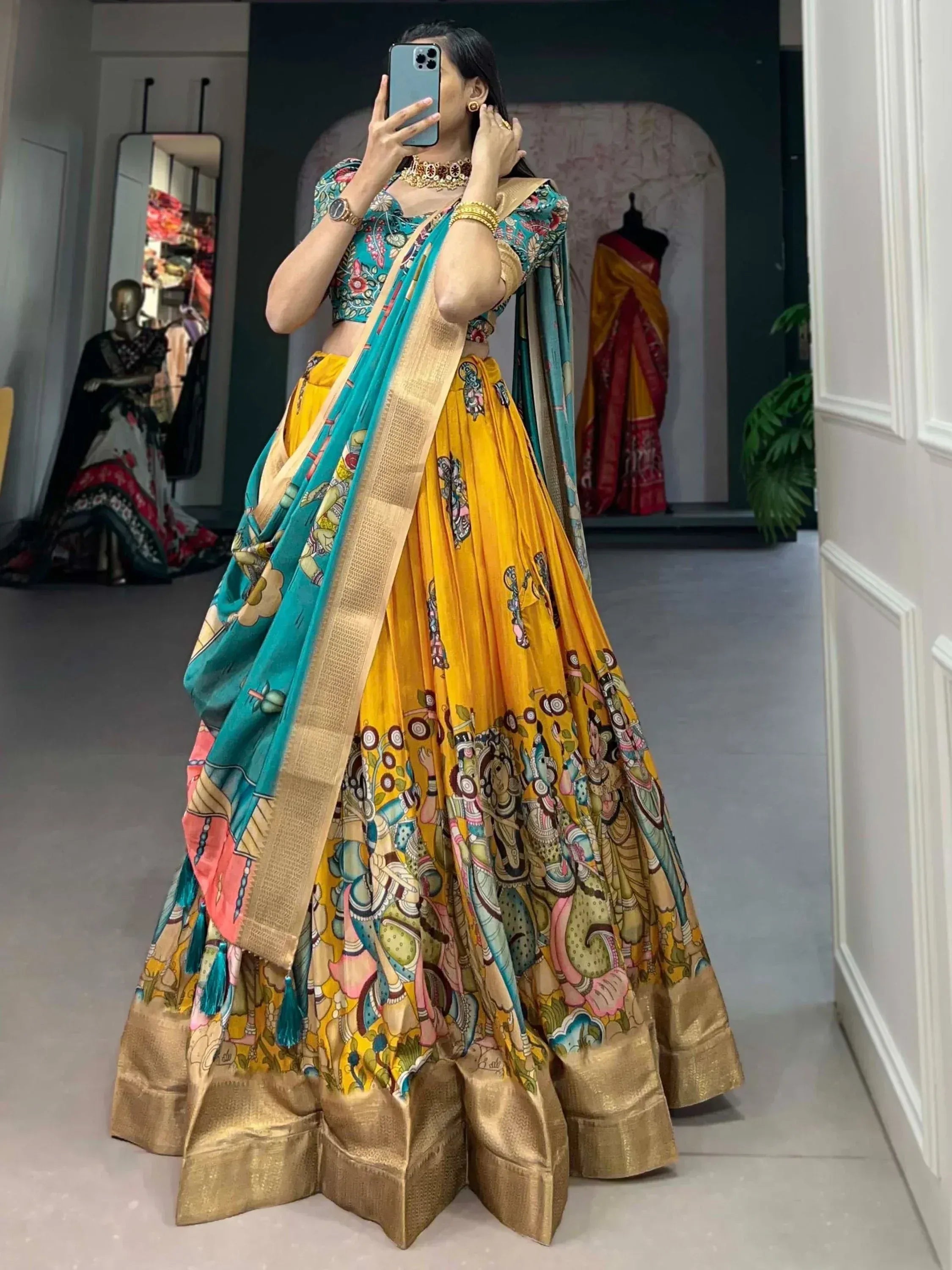Vibrant yellow and teal printed lehenga choli with gold border, perfect for Indian ethnic occasions