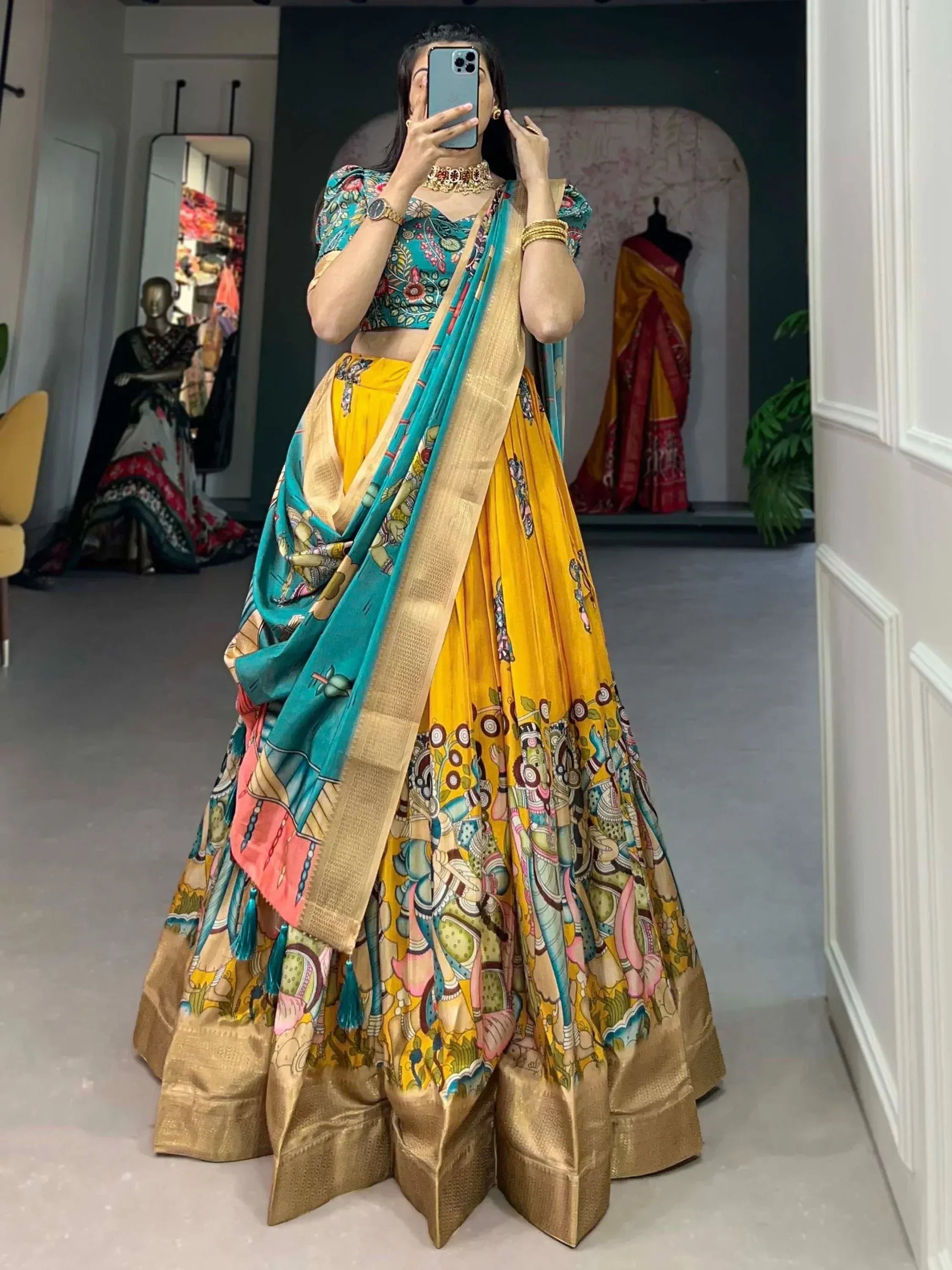 Vibrant yellow and teal printed lehenga choli with gold border, perfect for Indian ethnic wear occasions