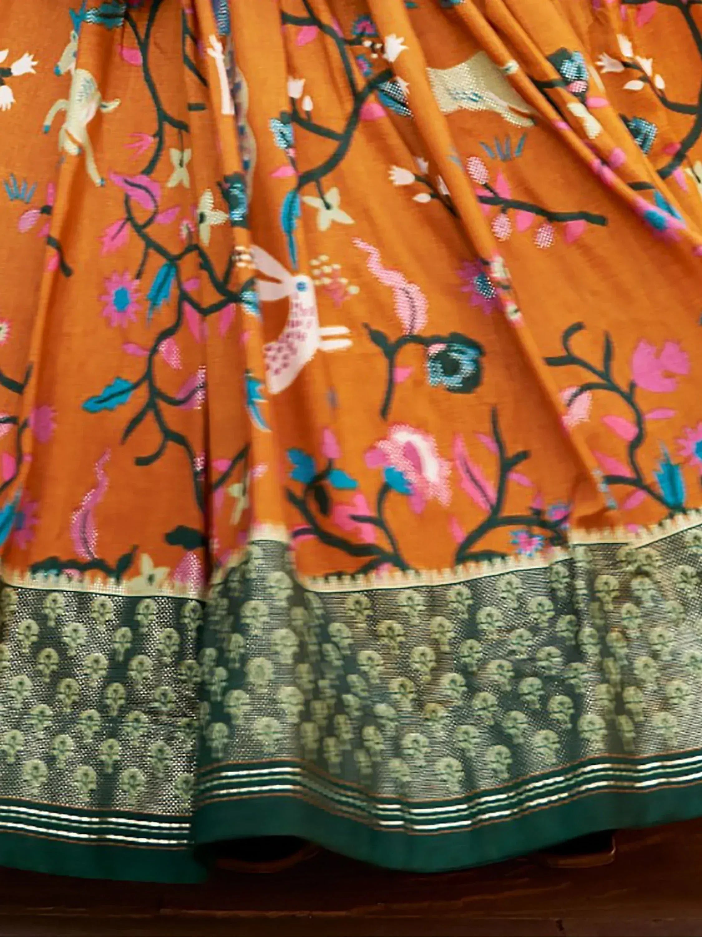 Orange floral printed lehenga with deer and bird motifs, green border, Indian ethnic wear