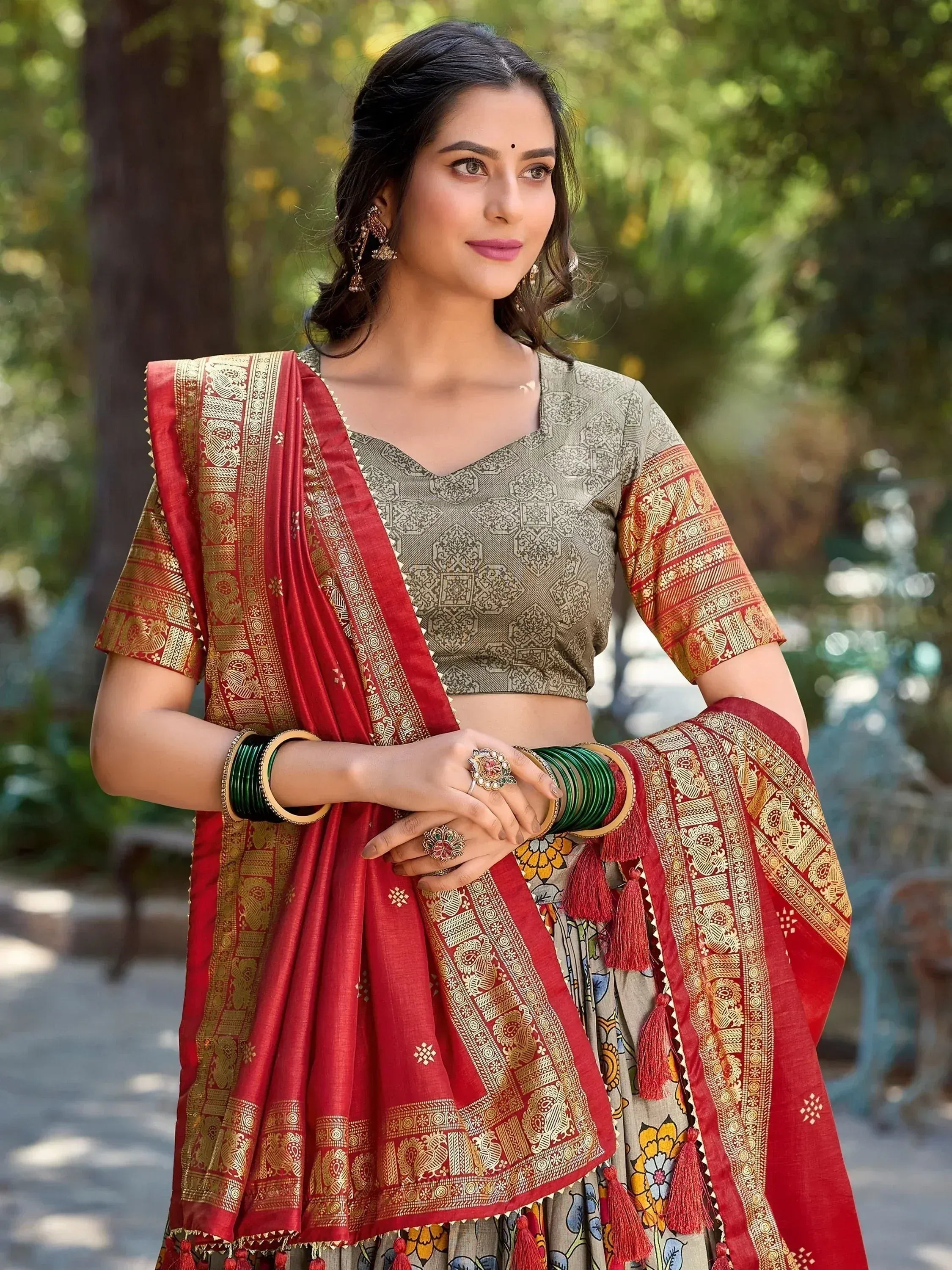 Woman in red and gold printed lehenga choli with floral skirt, traditional Indian ethnic wear