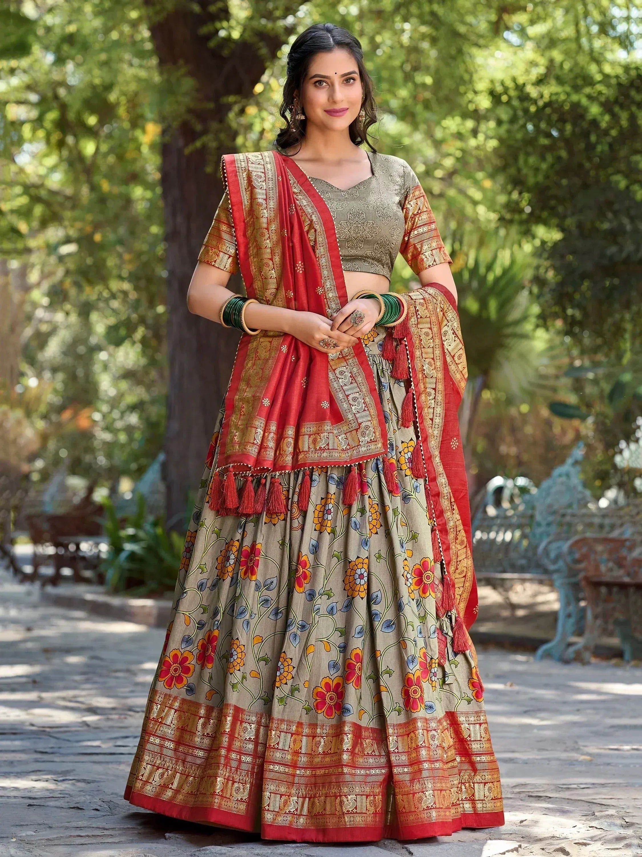 Woman in floral print lehenga choli with red dupatta, ethnic Indian wear for festive occasions