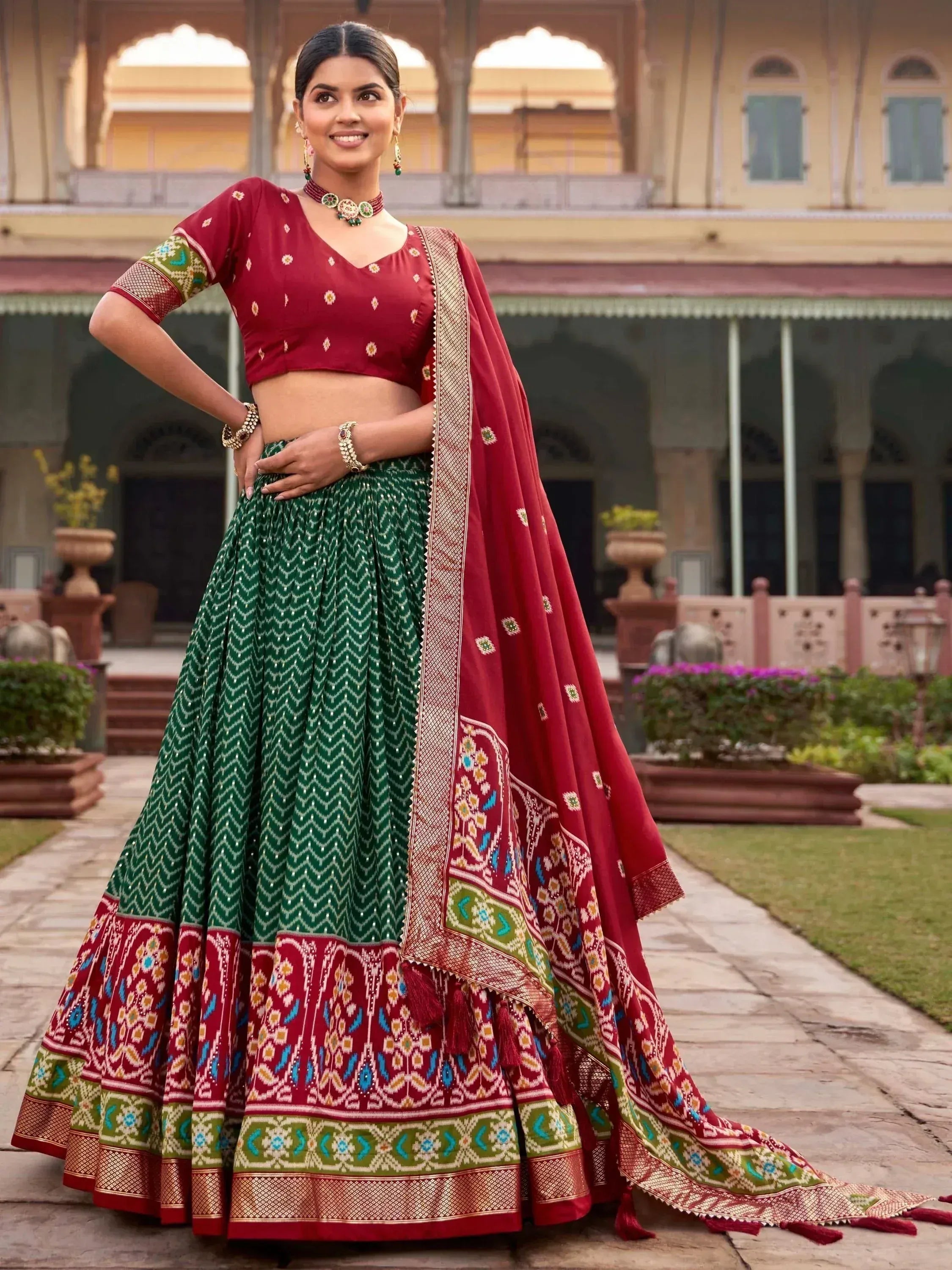 Red and green lehenga choli with intricate embroidery, perfect for Indian ethnic wear and festive occasions.