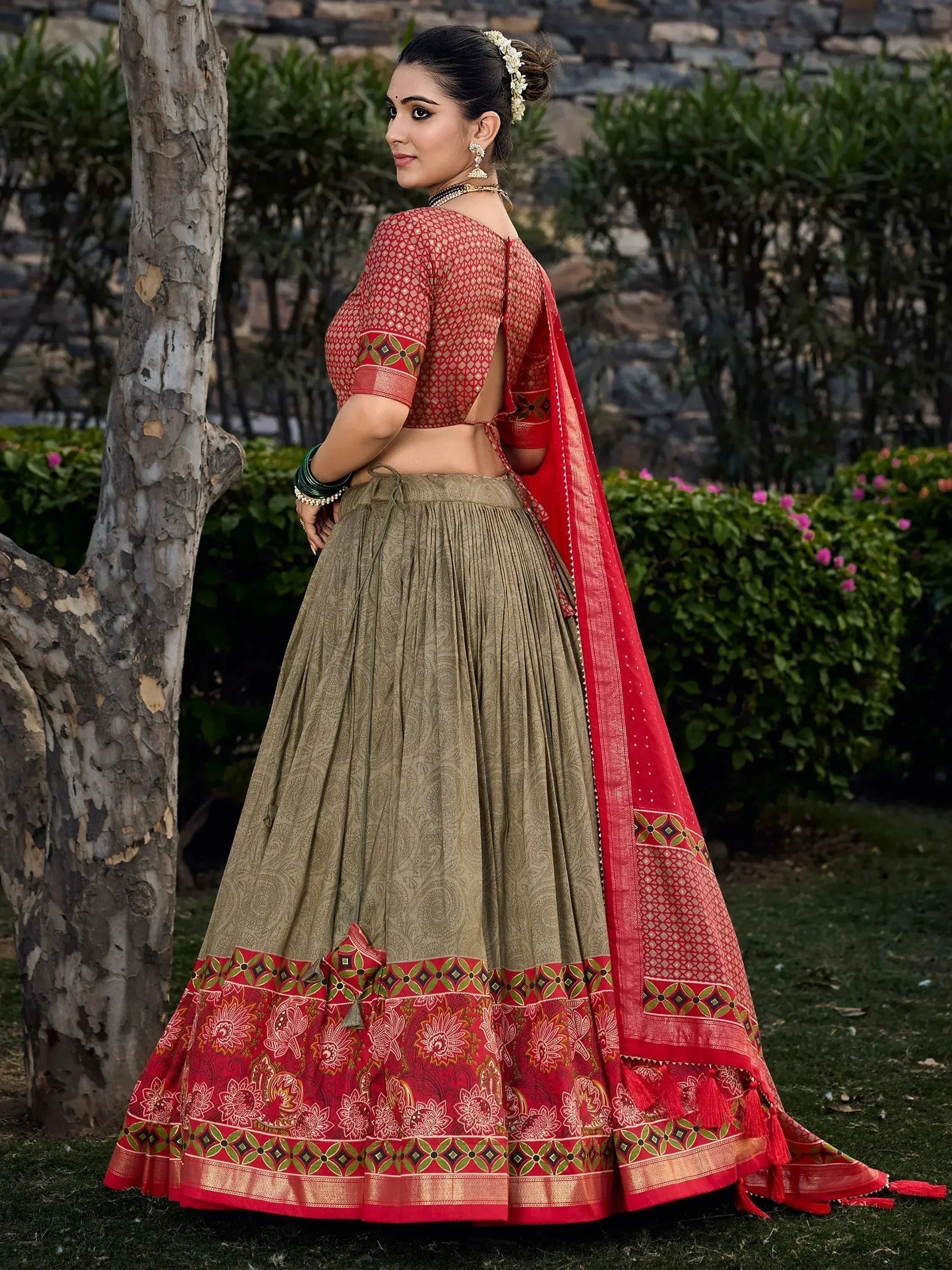 Red and olive green designer lehenga choli with floral border, perfect for Indian ethnic occasions