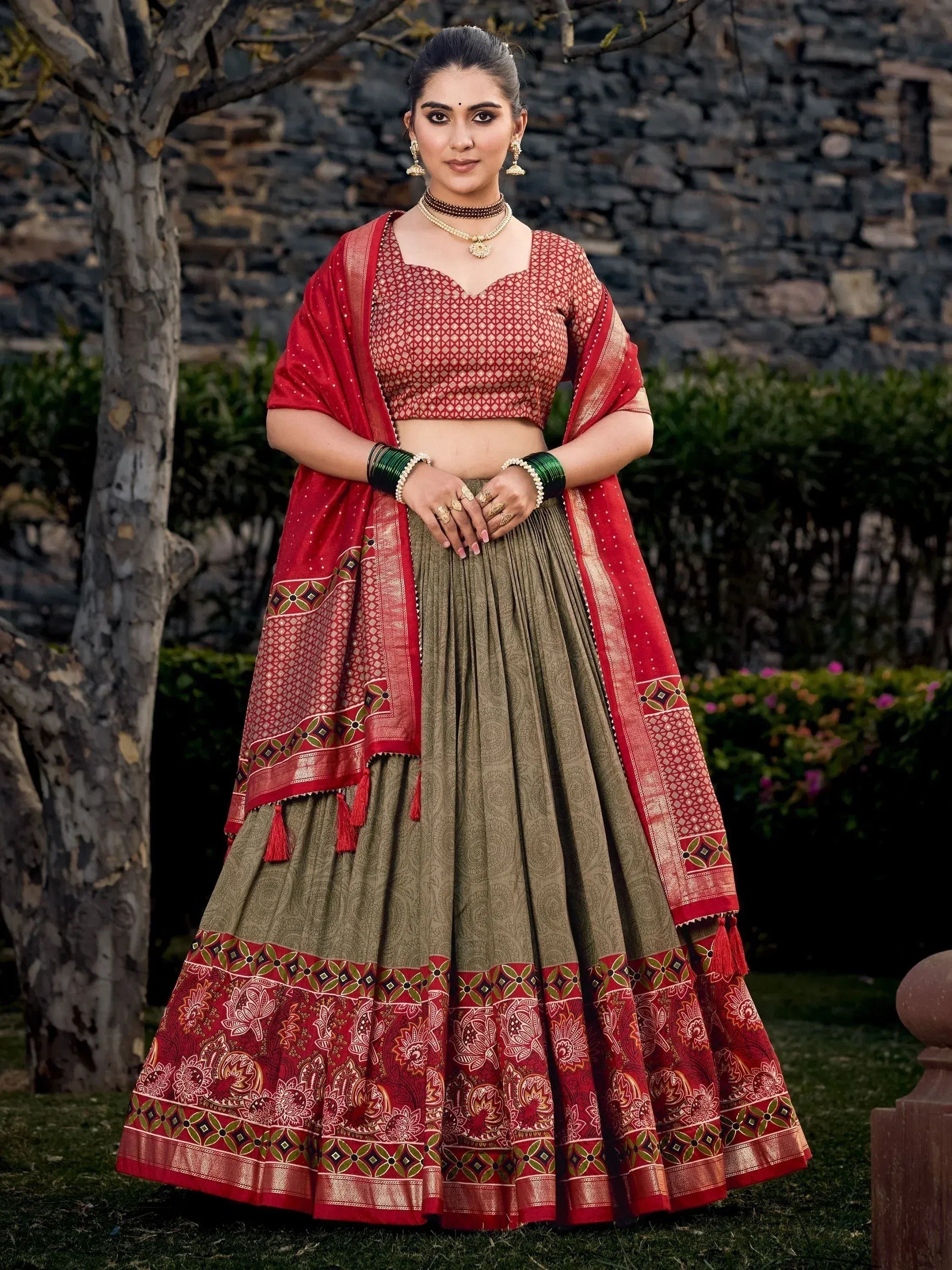 Red and olive green designer lehenga choli with intricate patterns, perfect for Indian ethnic wear occasions.