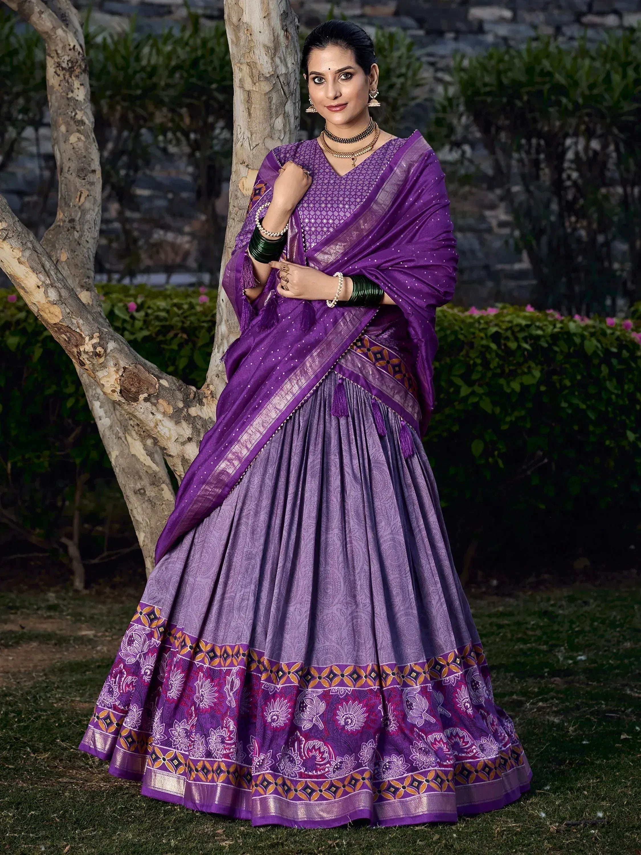 Purple designer lehenga choli with intricate patterns, perfect for Indian ethnic wear occasions