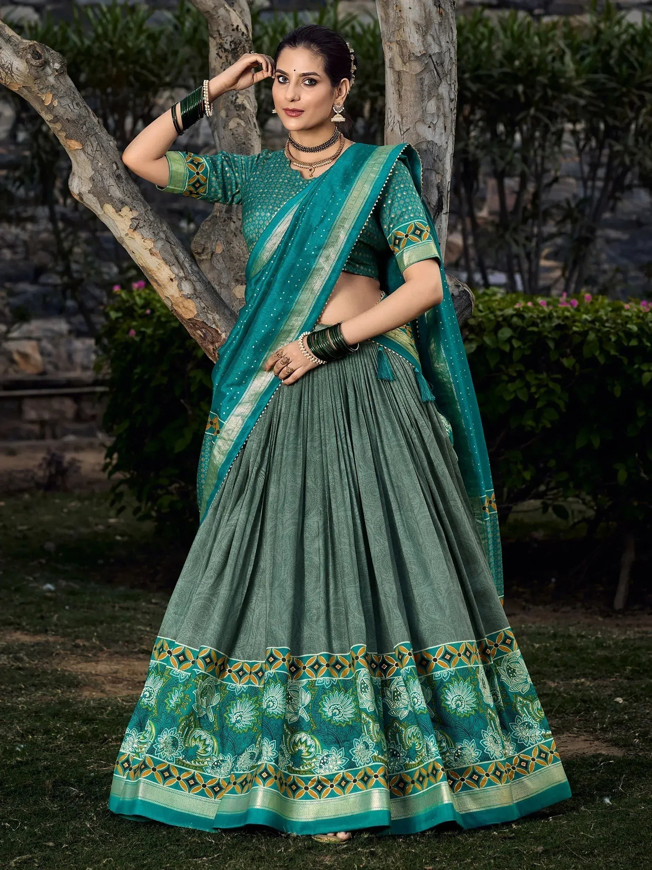 Teal green designer lehenga choli with floral border, perfect for Indian ethnic wear occasions