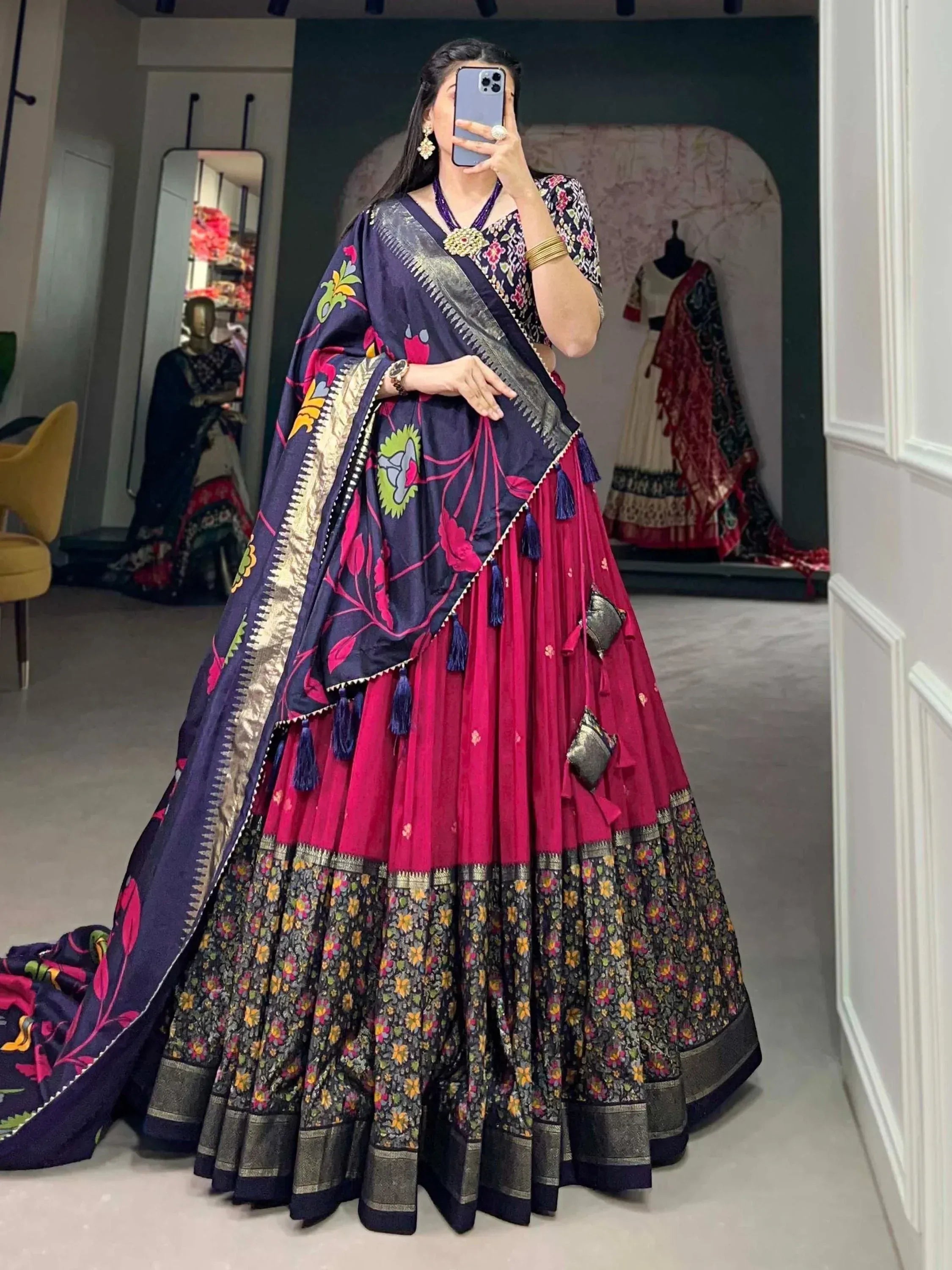 Woman in vibrant purple and pink floral lehenga choli with embroidered dupatta, perfect for Indian ethnic occasions