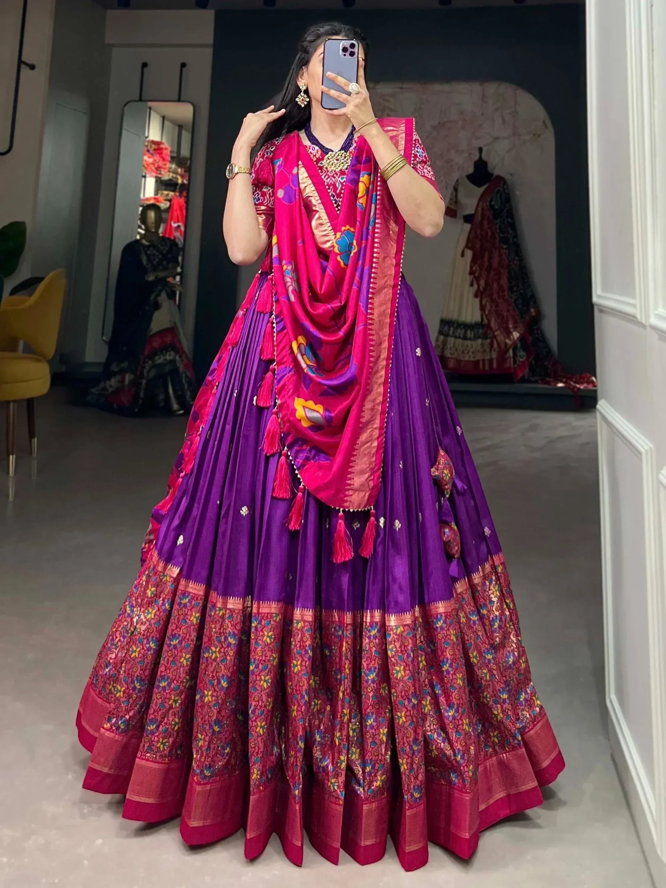 Vibrant purple and pink Indian lehenga choli with floral dupatta, perfect for weddings and festivals