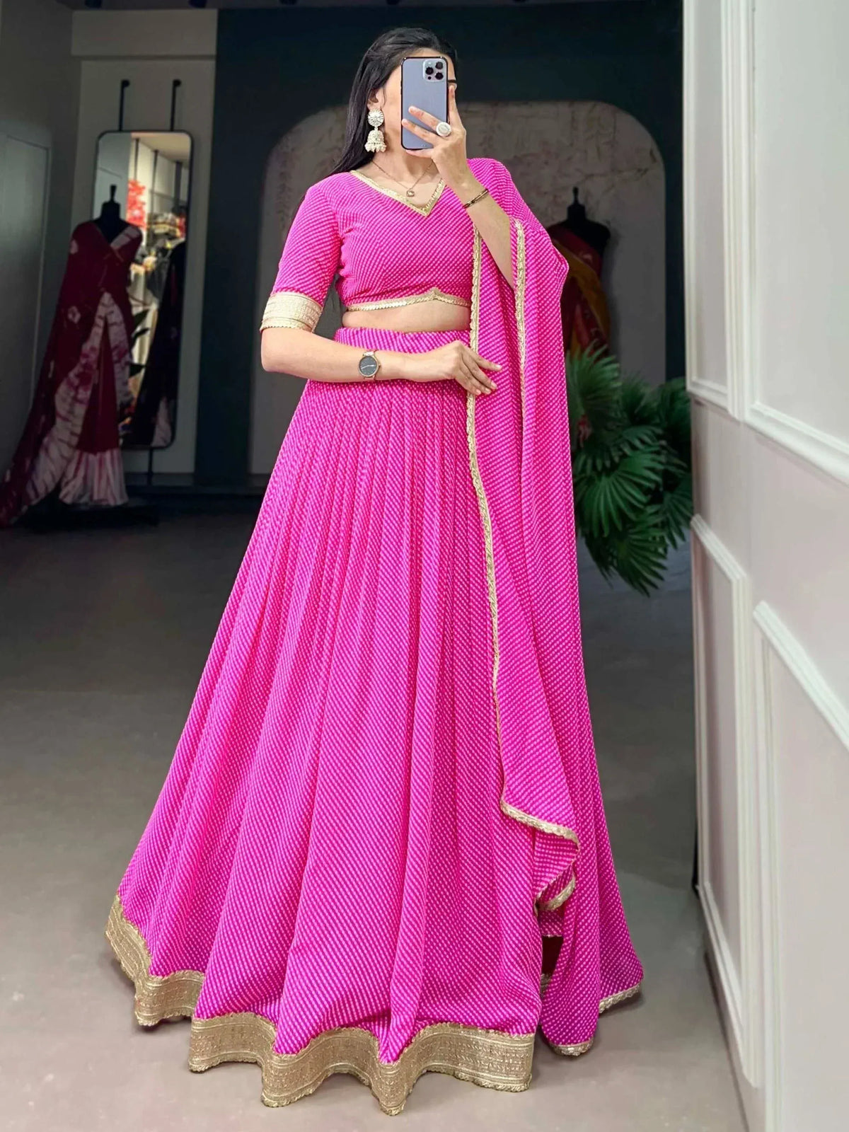 Vibrant pink lehenga choli with gold trim, perfect for Indian ethnic wear and festive occasions.