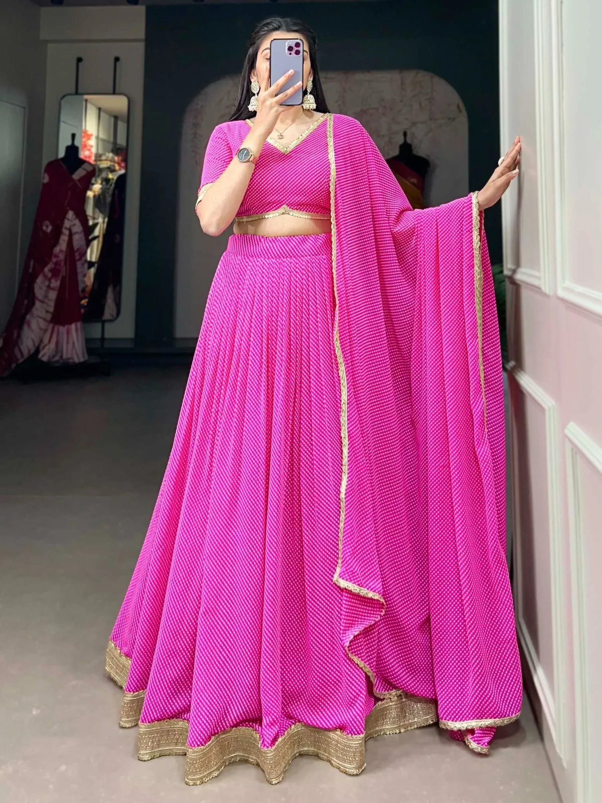 Pink ethnic lehenga choli with gold trim, perfect for Indian weddings and festive occasions.