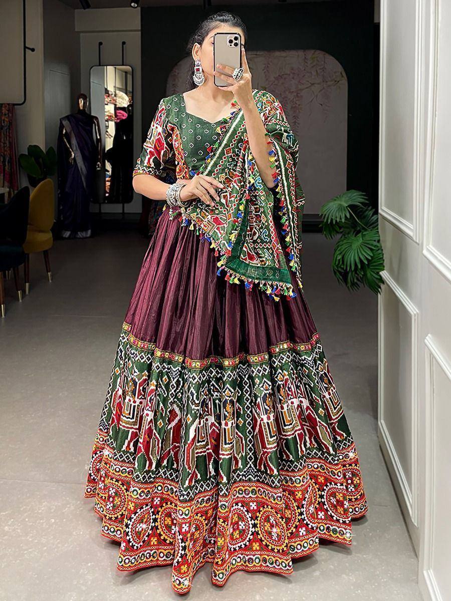 Woman in colorful embroidered lehenga choli with mirror work, perfect for Indian ethnic occasions