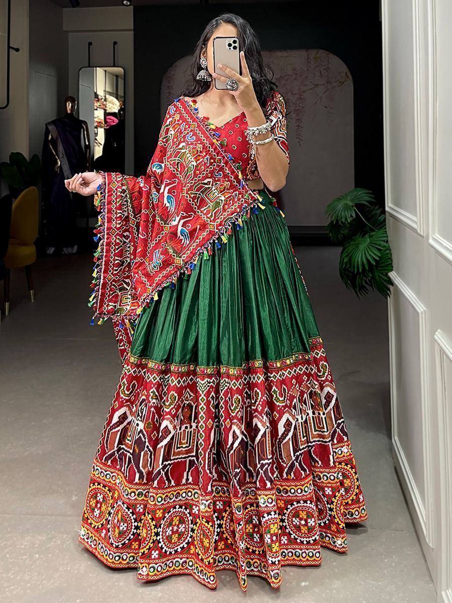 Red and green embroidered lehenga choli with mirror work, perfect for Indian ethnic wear occasions.