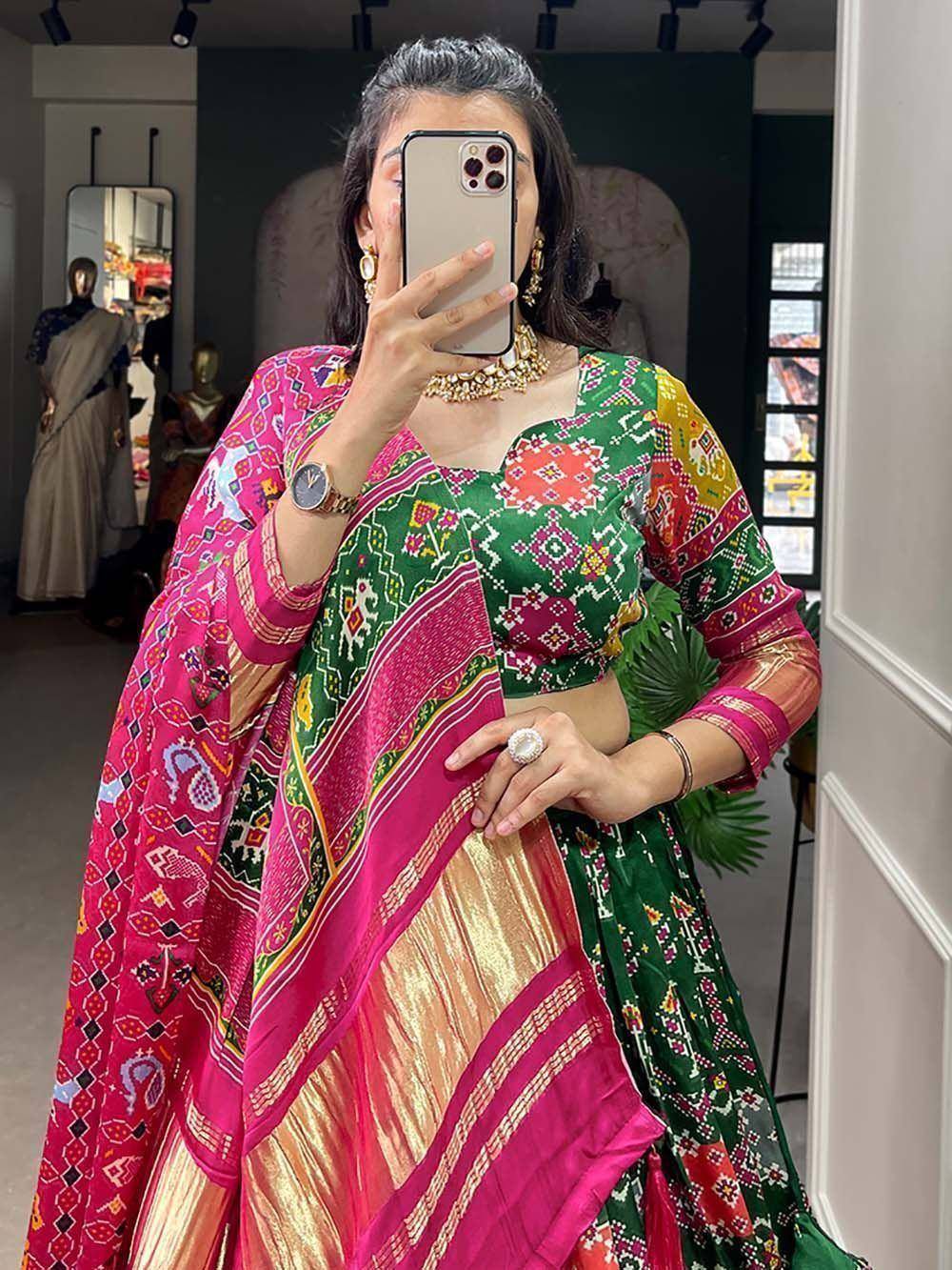 Vibrant green and pink embroidered lehenga choli with mirror work, perfect for festive occasions