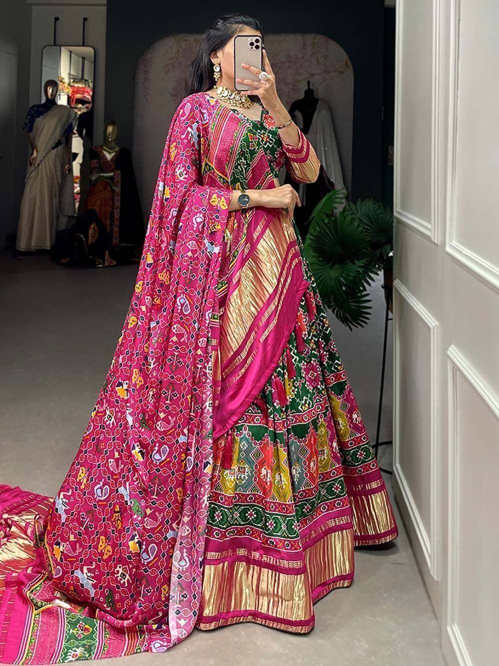 Vibrant pink and green printed lehenga choli with gold border, perfect for Indian ethnic occasions