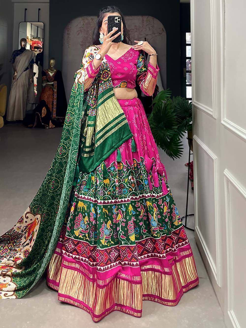 Vibrant pink and green embroidered lehenga choli with mirror work, perfect for Indian ethnic wear events